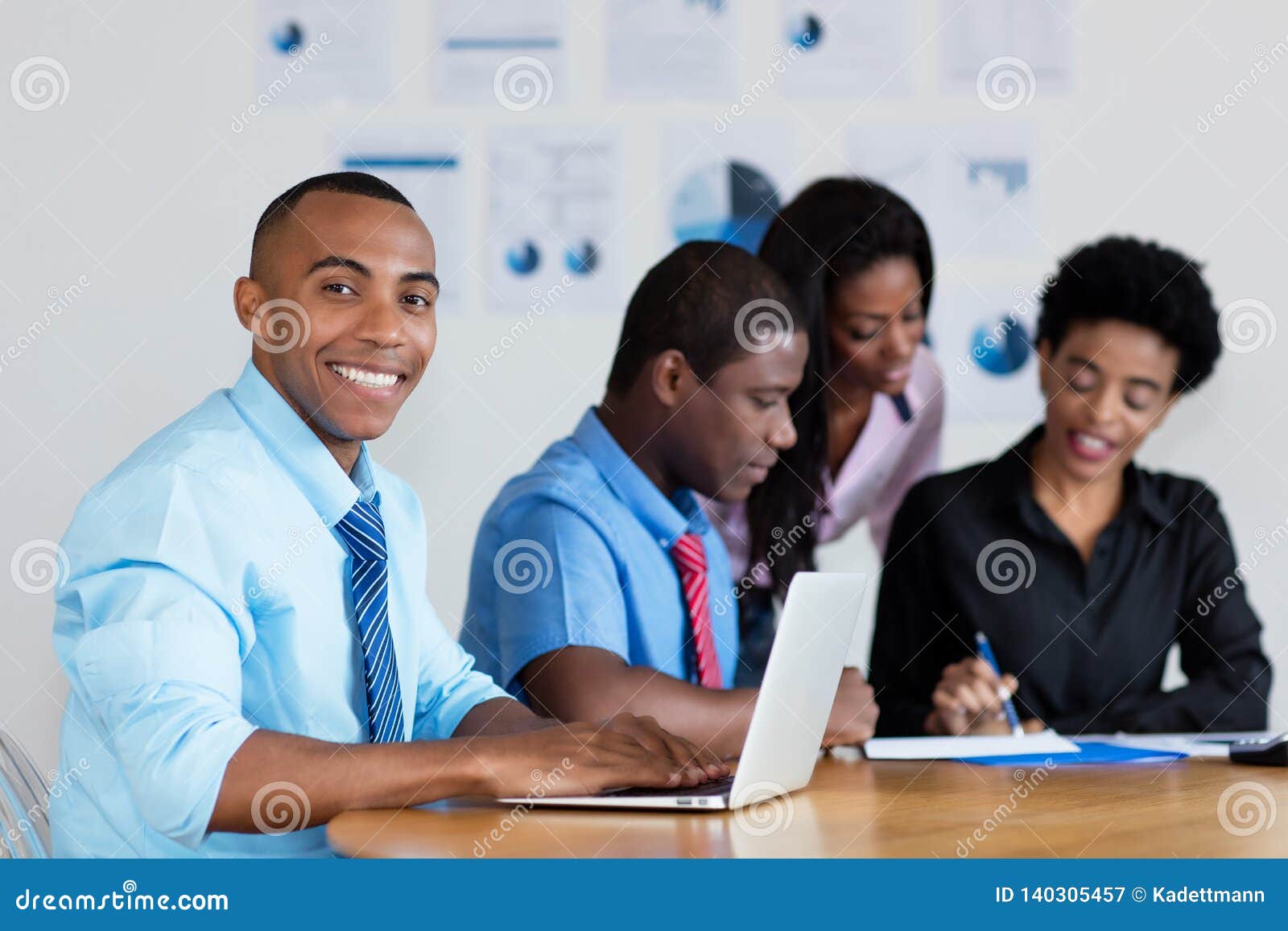 handsome african american businessman with business team at office