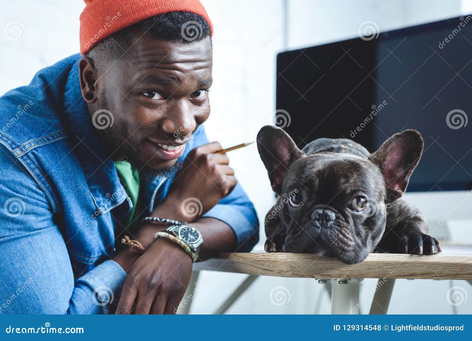 handsome african american man with frenchie dog