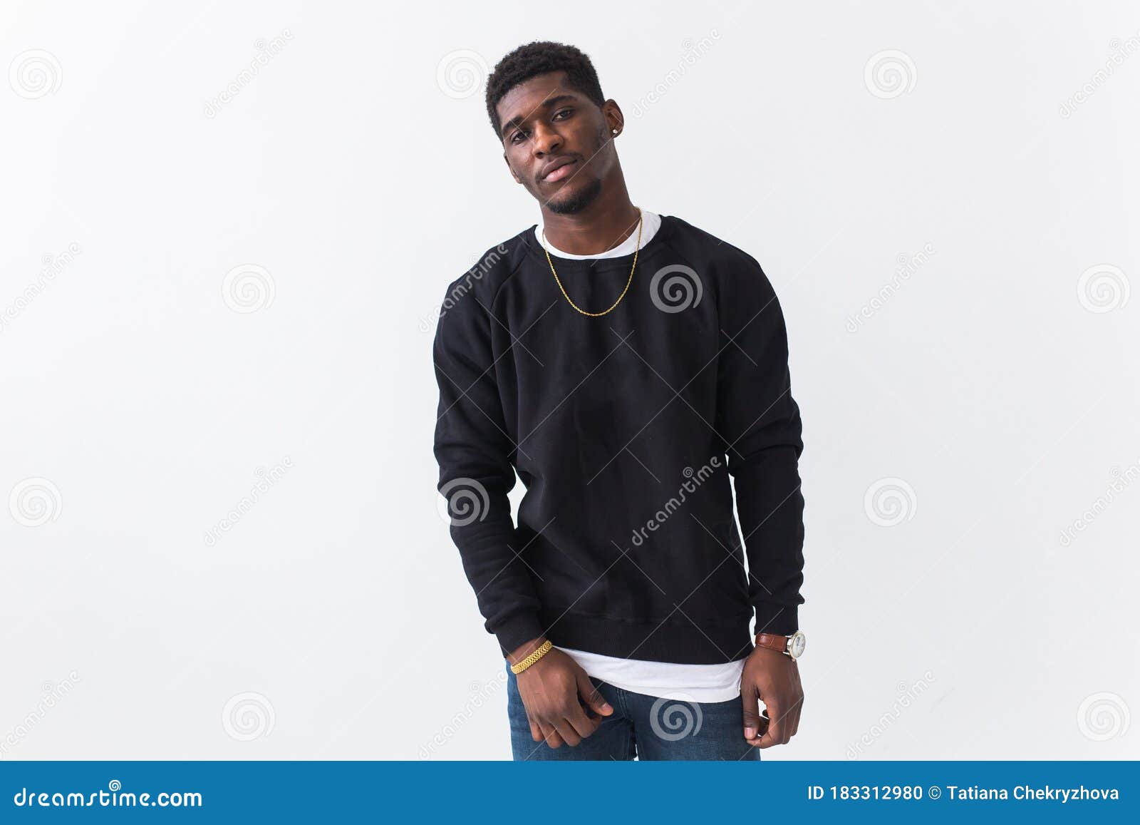 From below confident young Asian male with Afro hairstyle in yellow  sweatshirt looking at camera against tiled wall with shadow in sunlight  Stock Photo - Alamy