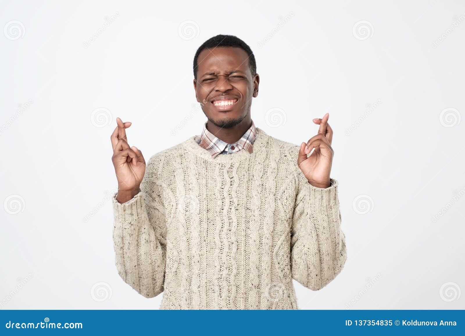 Handsome African Male Standing with Crossed Fingers Having Pleading ...