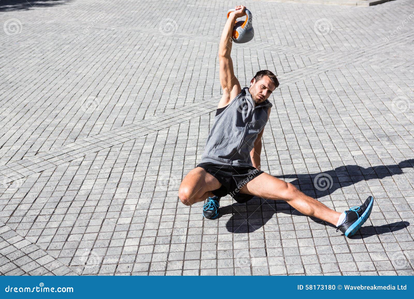 handsome athlete exercising turkish get up