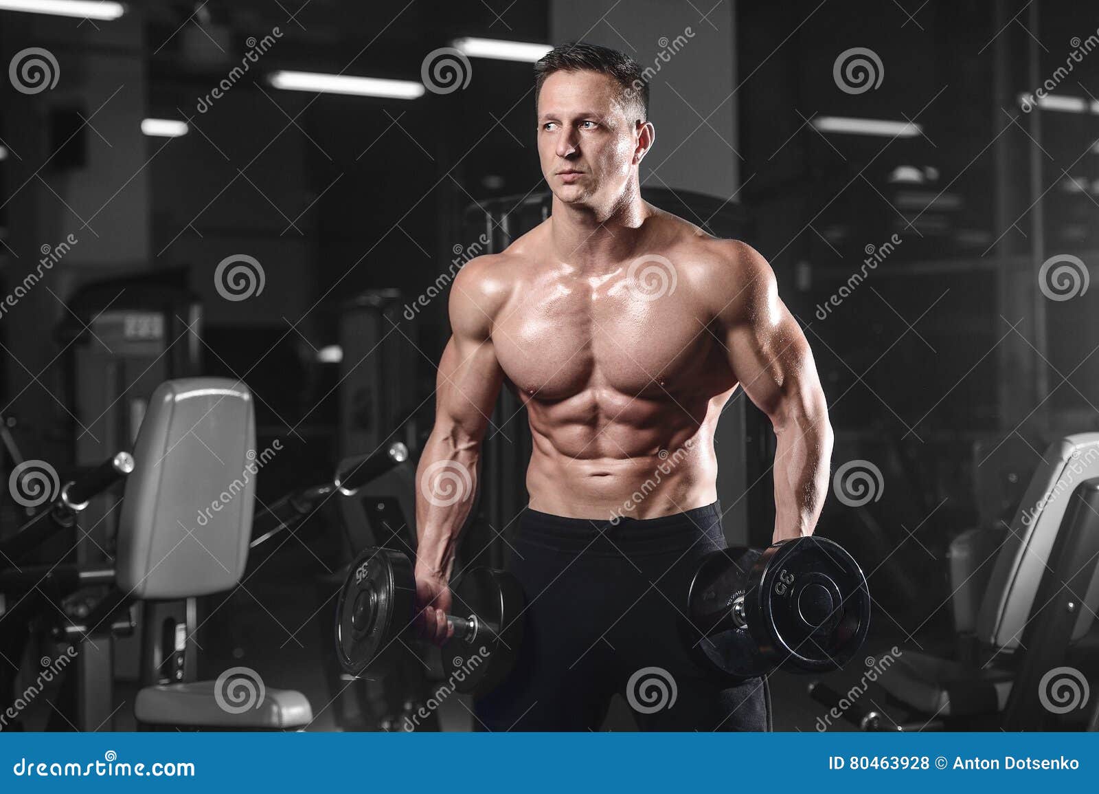 Handsome Athletic Fitness Man Posing And Trains In The Gym Stock Photo