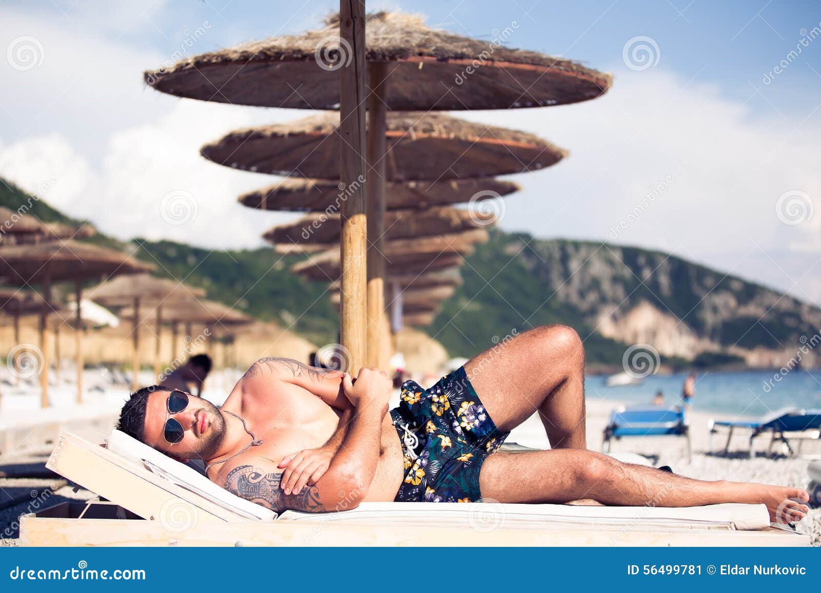 Handsome Attractive Muscular Man Lying on Sunbed and  Man  with Tattoo Sunbathing, Spf Protection and Leisure Stock Image - Image of  relaxation, leisure: 56499781