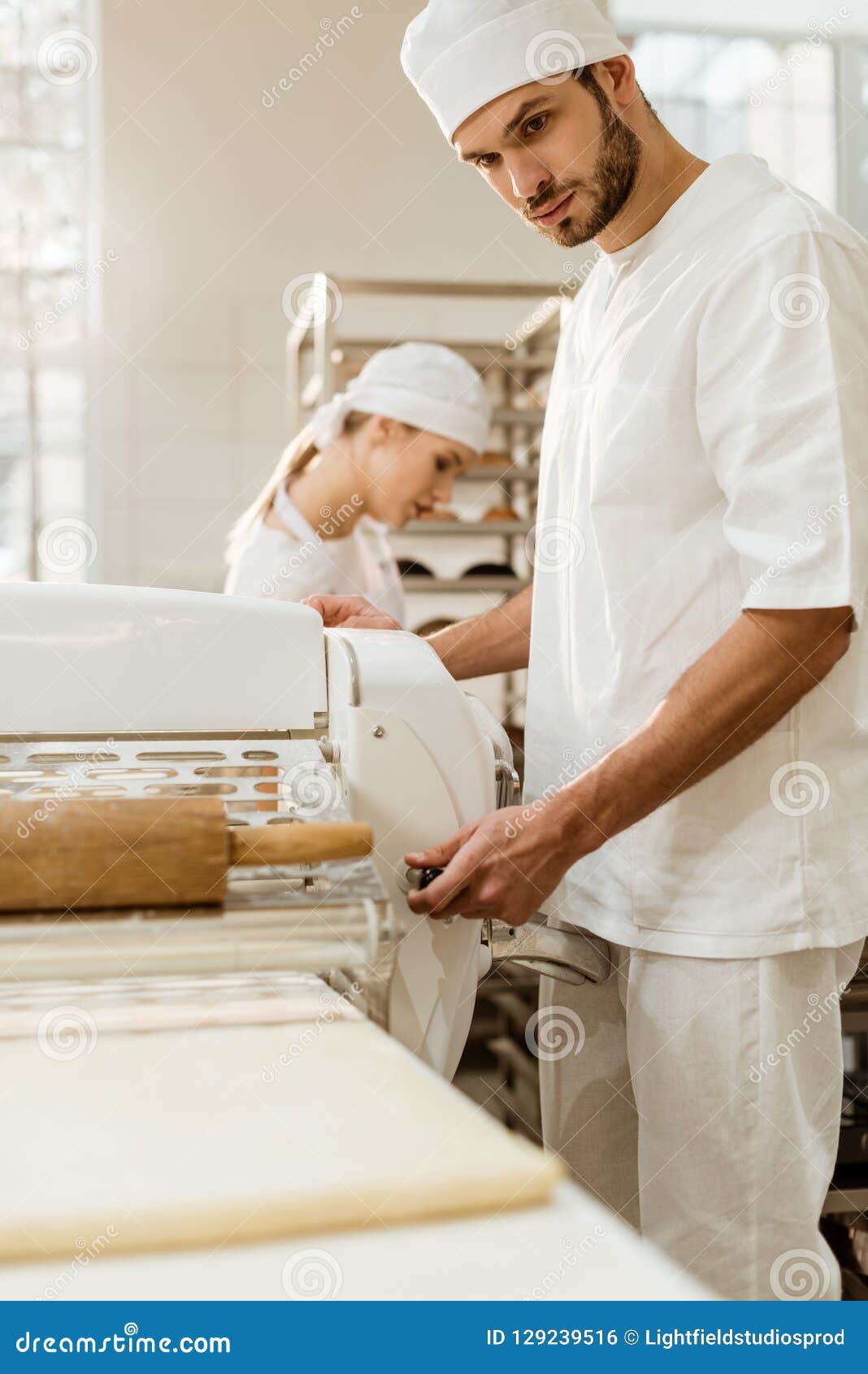 Handsome Baker Working with Industrial Dough Roller Stock Photo Image