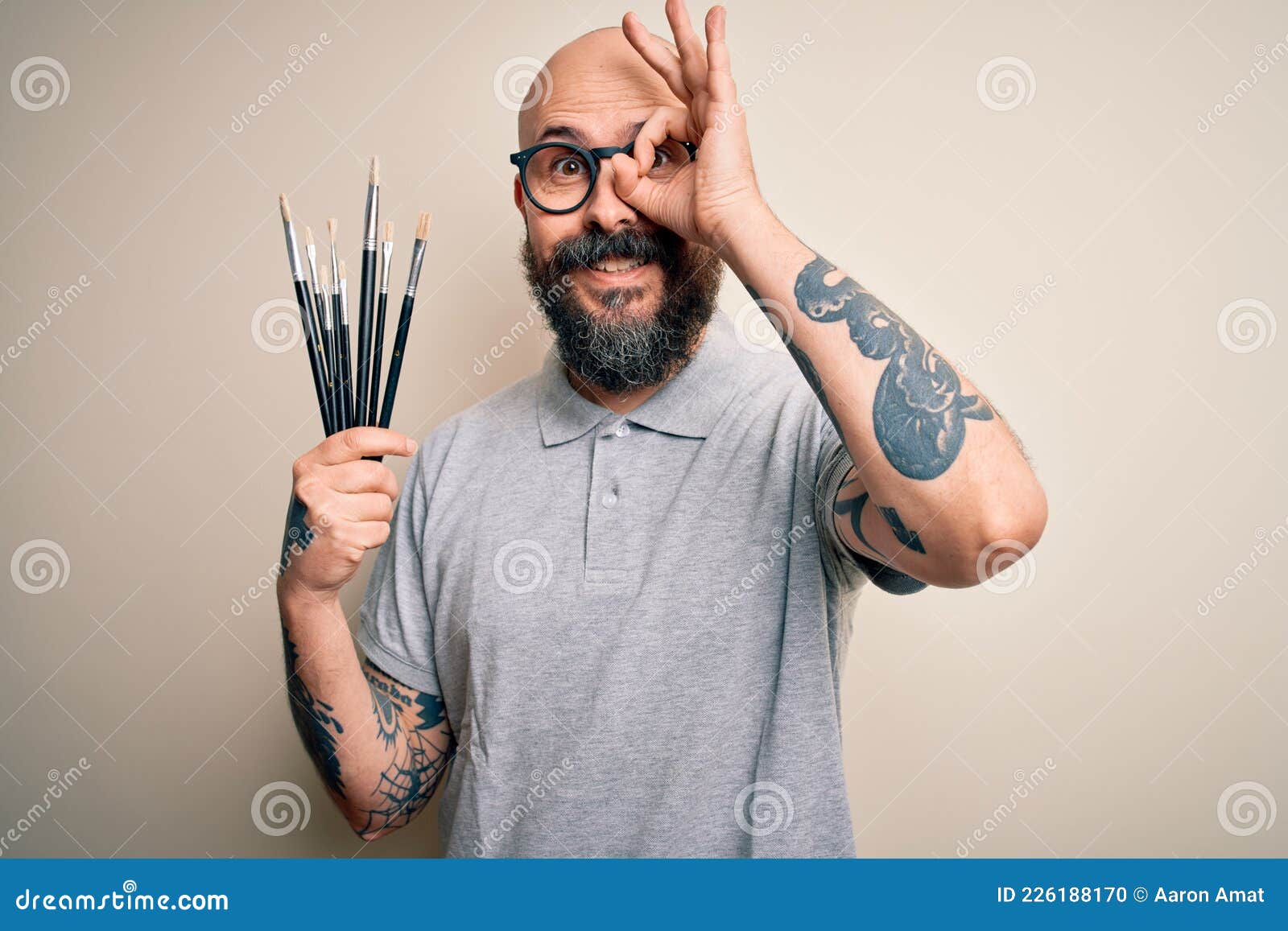 Handsome Bald Artist Man with Beard and Tattoo Painting Using Painter Brushes with Happy Face Smiling Doing Ok Sign with Hand on Stock Photo - Image of painter, handsome: 226188170 Handsome Bald Artist Man with Beard and Tattoo Painting Using Painter Brushes with Happy Face Smiling Doing Ok Sign with Hand on Stock Photo - Image of painter, handsome: 226188170