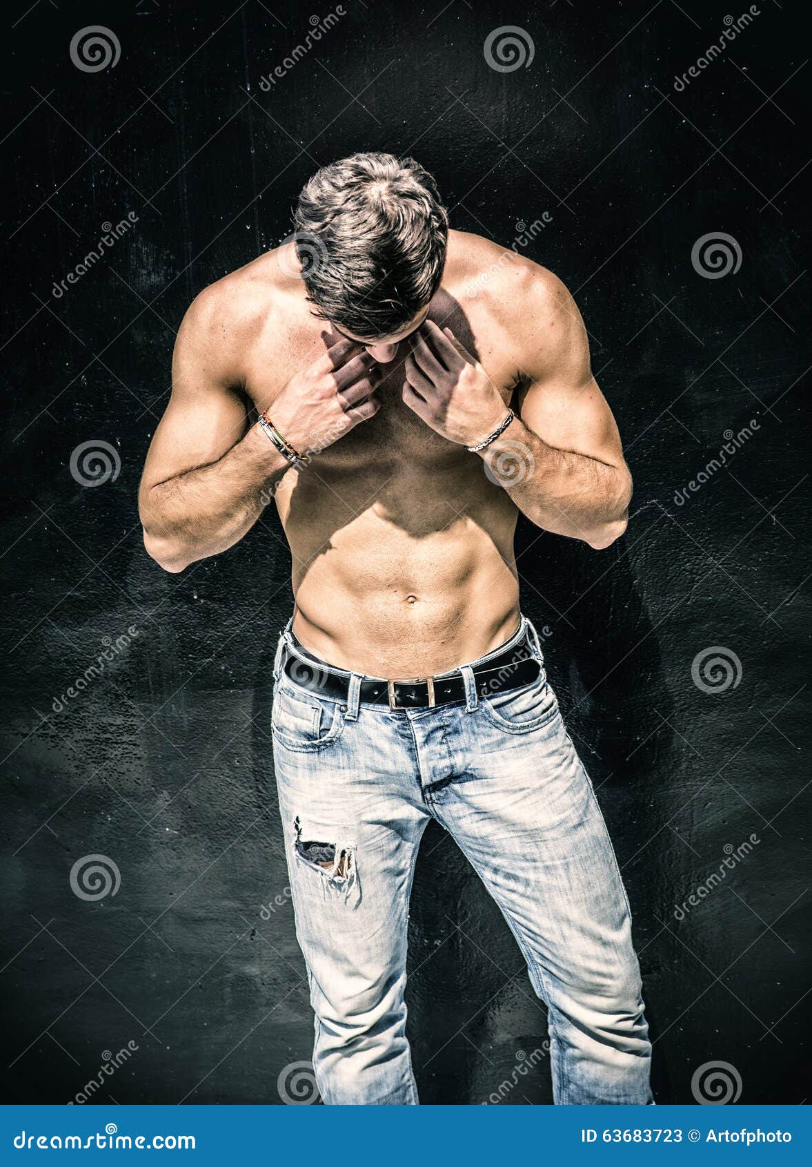 handsome bearded shirtless young man standing
