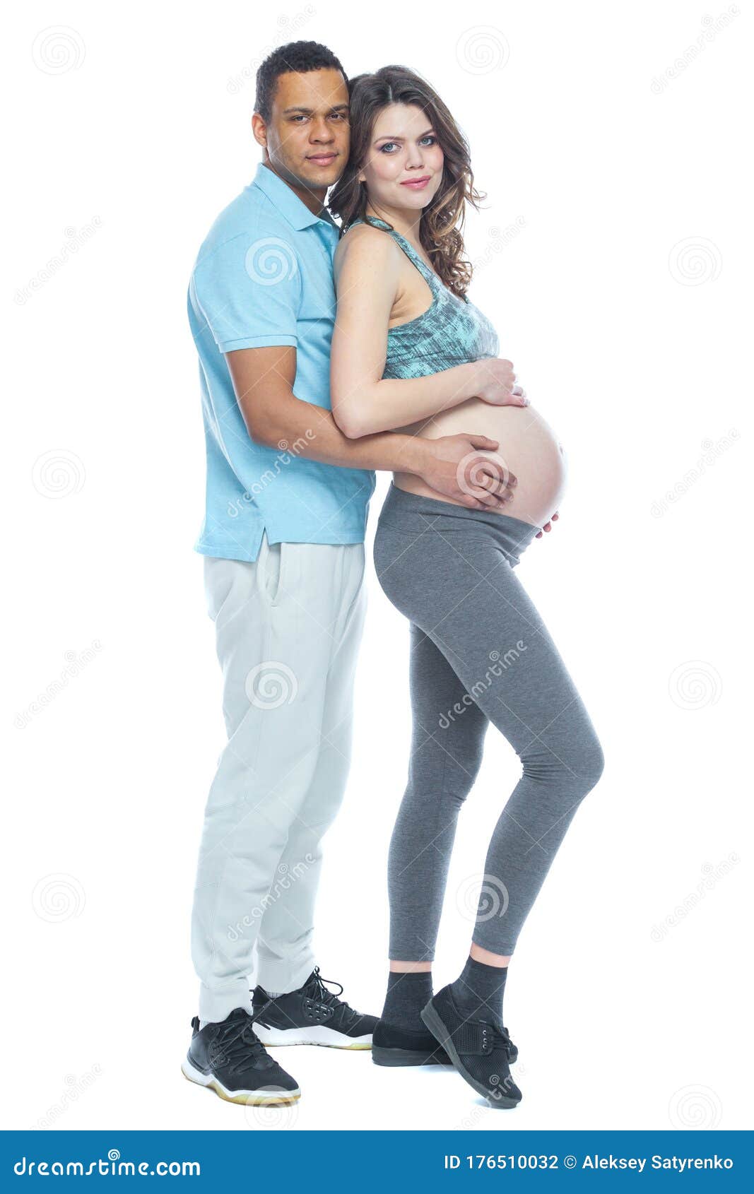 Handsome Black Man and His Beautiful Pregnant Wife are Hugging and Smiling while pic