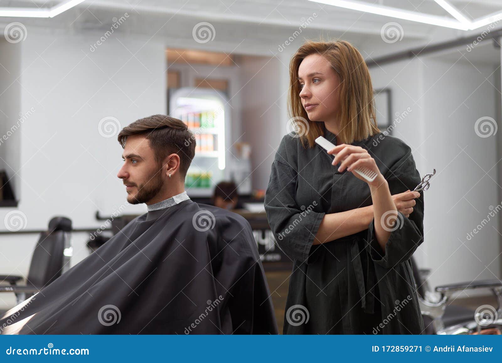 Handsome Blue Eyed Man Sitting in Barber Shop. Hairstylist Hairdresser Woman  Cutting His Hair. Female Barber Stock Image - Image of haircut, lifestyle:  172859271