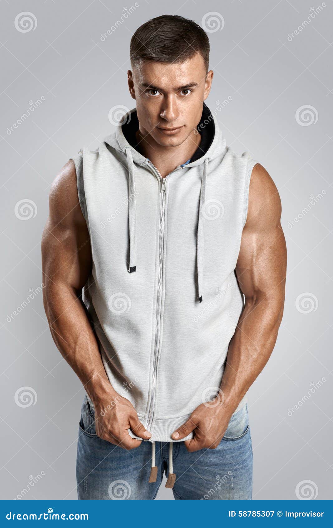 handsome bodybuilder wearing gray sleeveless hoodie