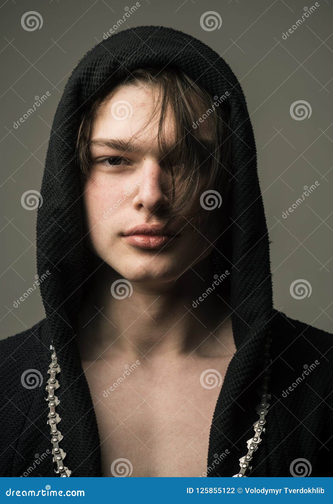 Handsome Boy in Black Hood with Medium Length Layered Dark Hair with Long  Chain Around His Neck Standing Isolated on Stock Photo - Image of hood, hair:  125855122