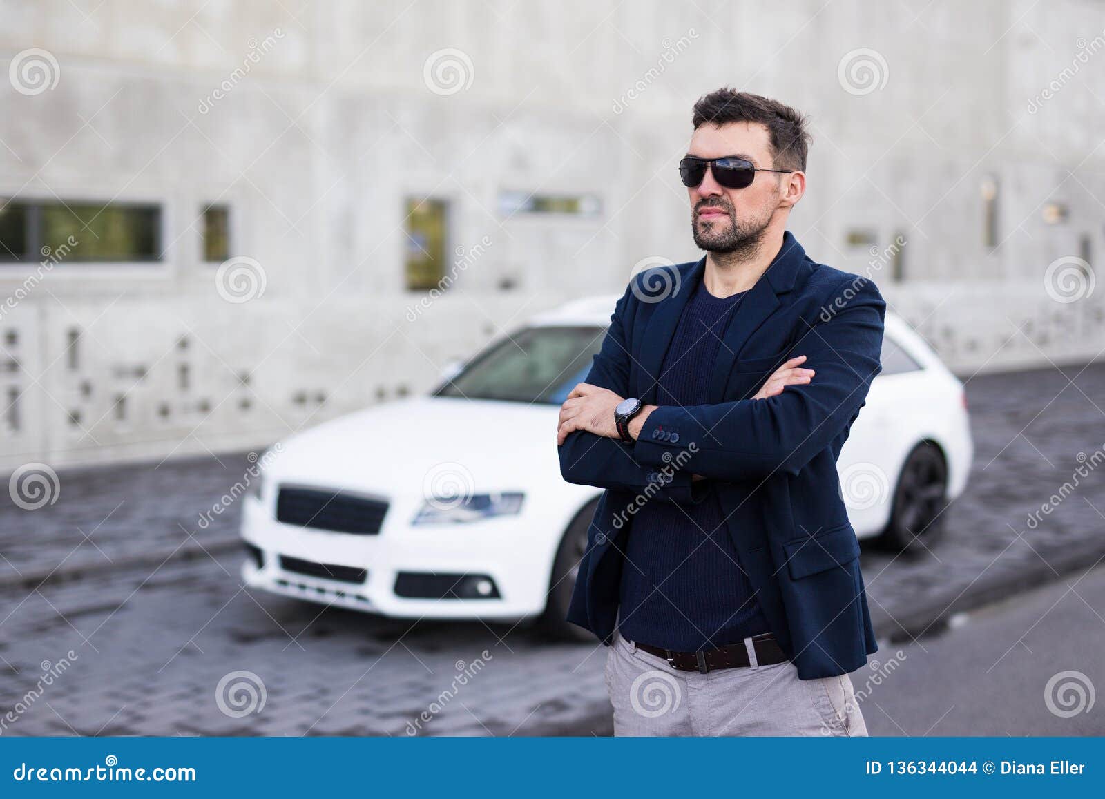 fashionable handsome man and beautiful girl posing near car Stock Photo by  LightFieldStudios