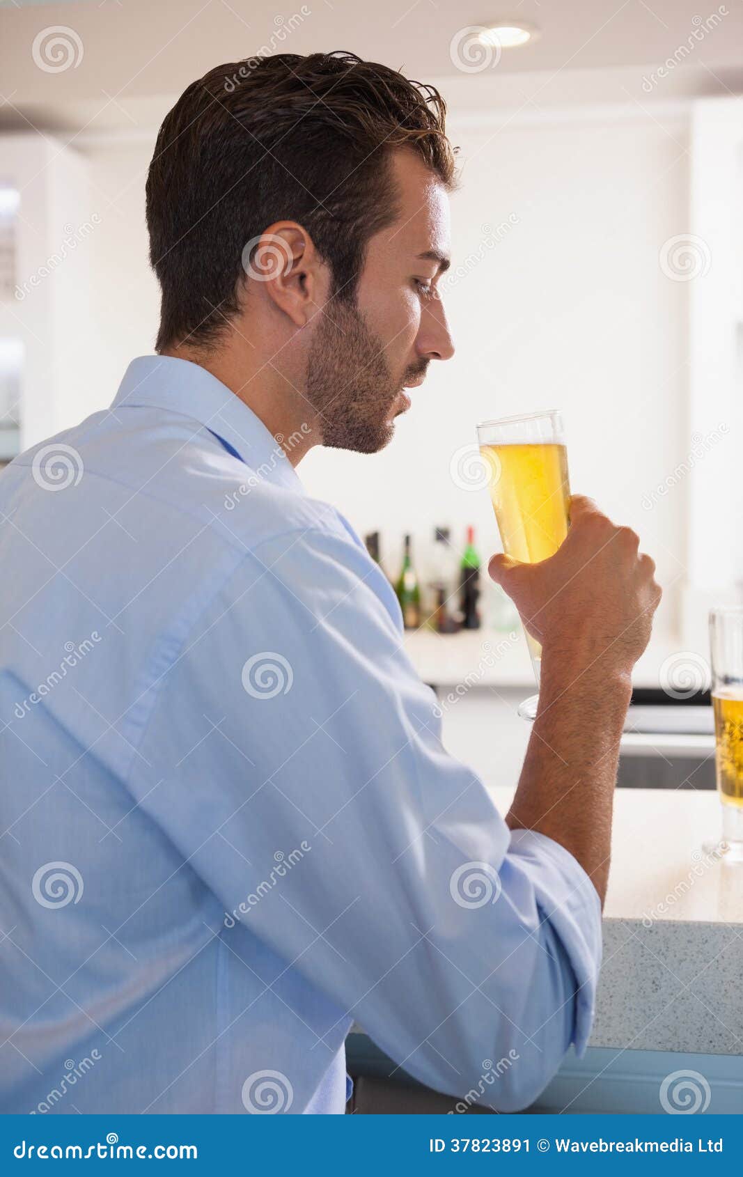 Handsome Businessman Drinking Glass of Beer after Work Stock Image