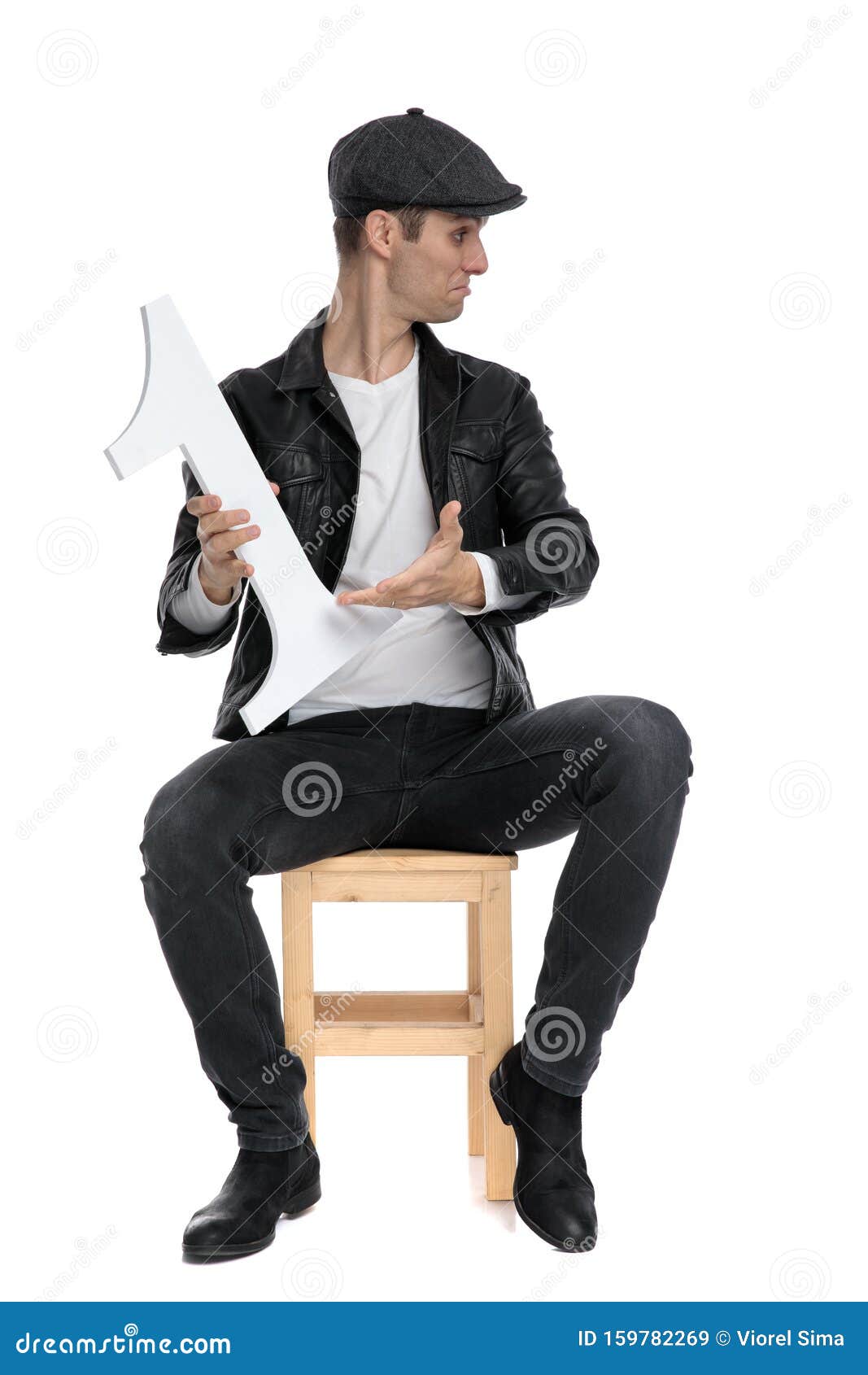 seated casual man presenting number one to a side cocky