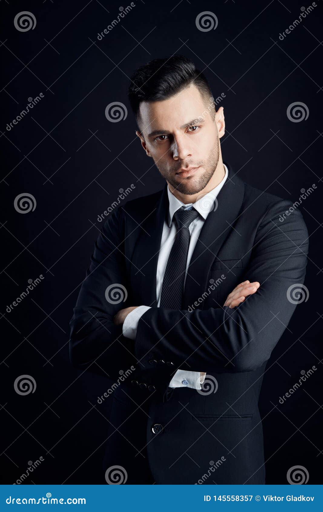 Handsome Confident Man In Black Suit With Arms Crossed On Dark ...