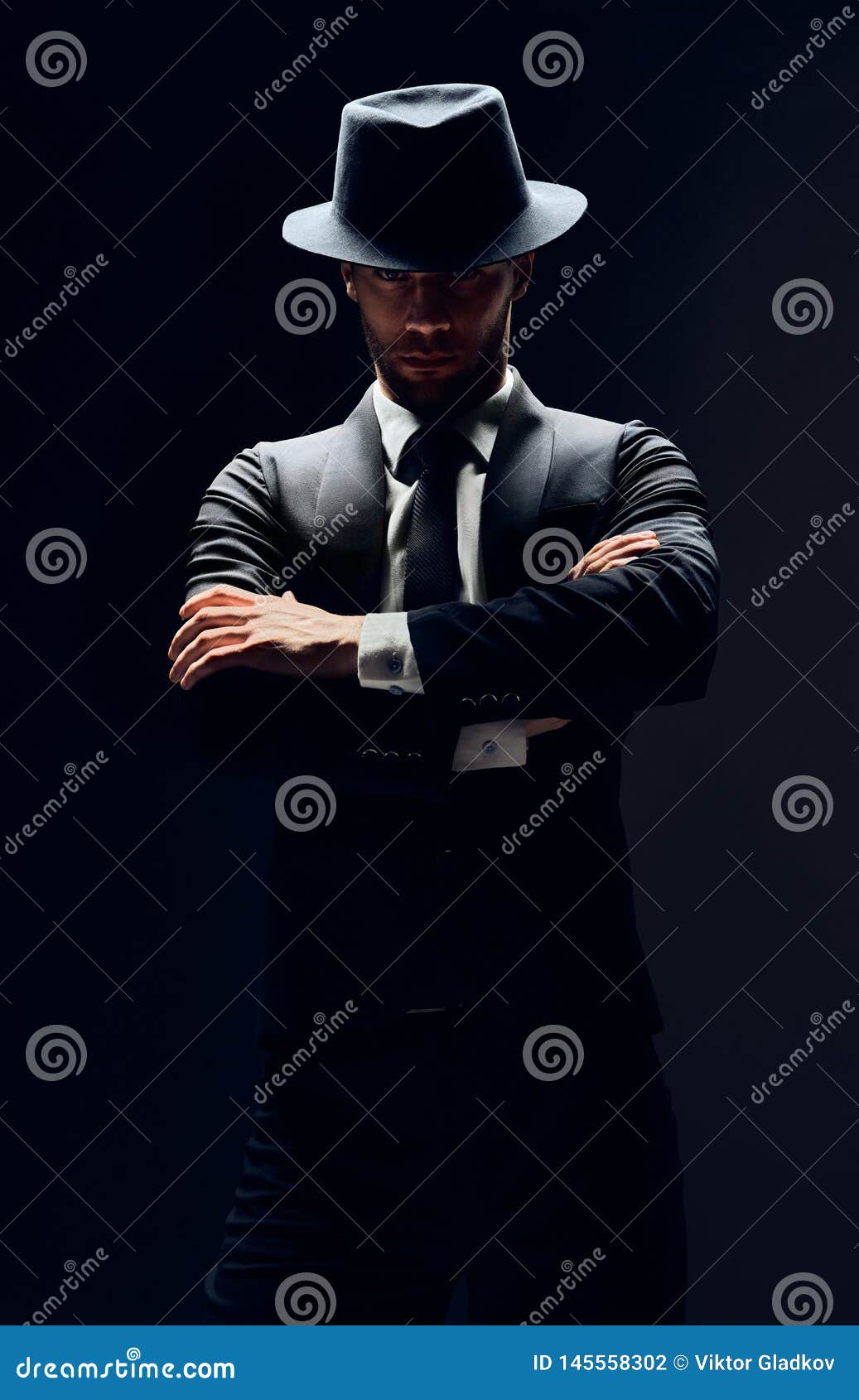 Handsome Confident Man In Black Suit And Hat With Arms Crossed On Dark ...