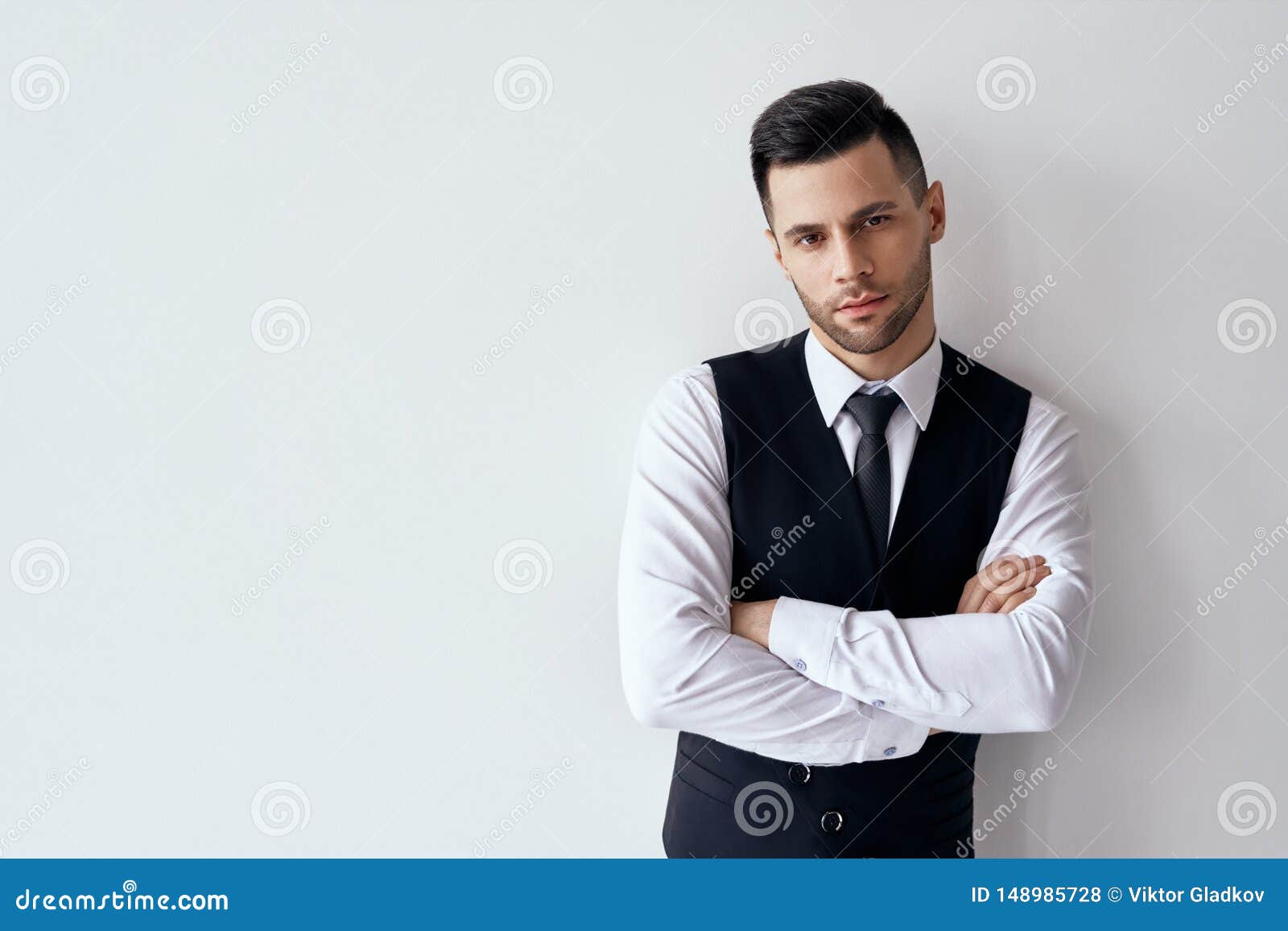 Handsome Confident Man In Elegant Suit With Crossed Arms On White ...