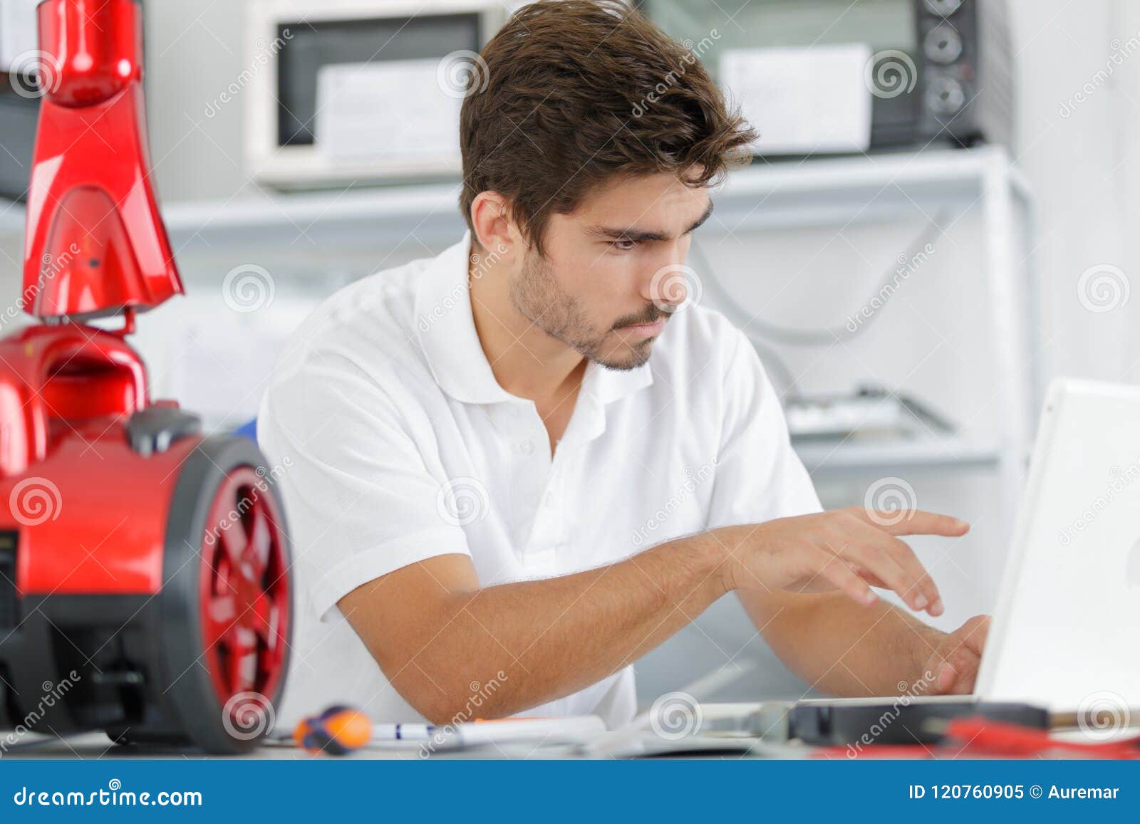 Handsome Engineer Researching Manufacturing Issues with Vacuum Cleaner