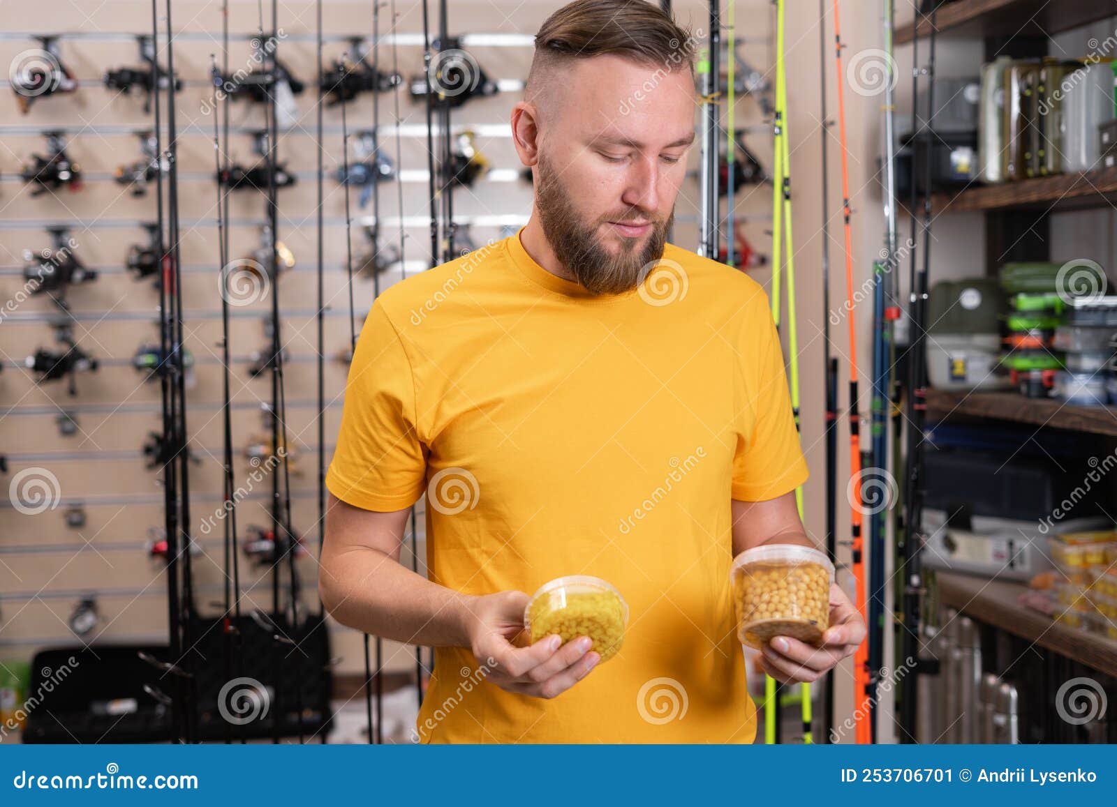 Handsome Fisherman Choosing Fishing Bait for Fishing in the Sports Shop.  Stock Image - Image of market, wobbler: 253706701