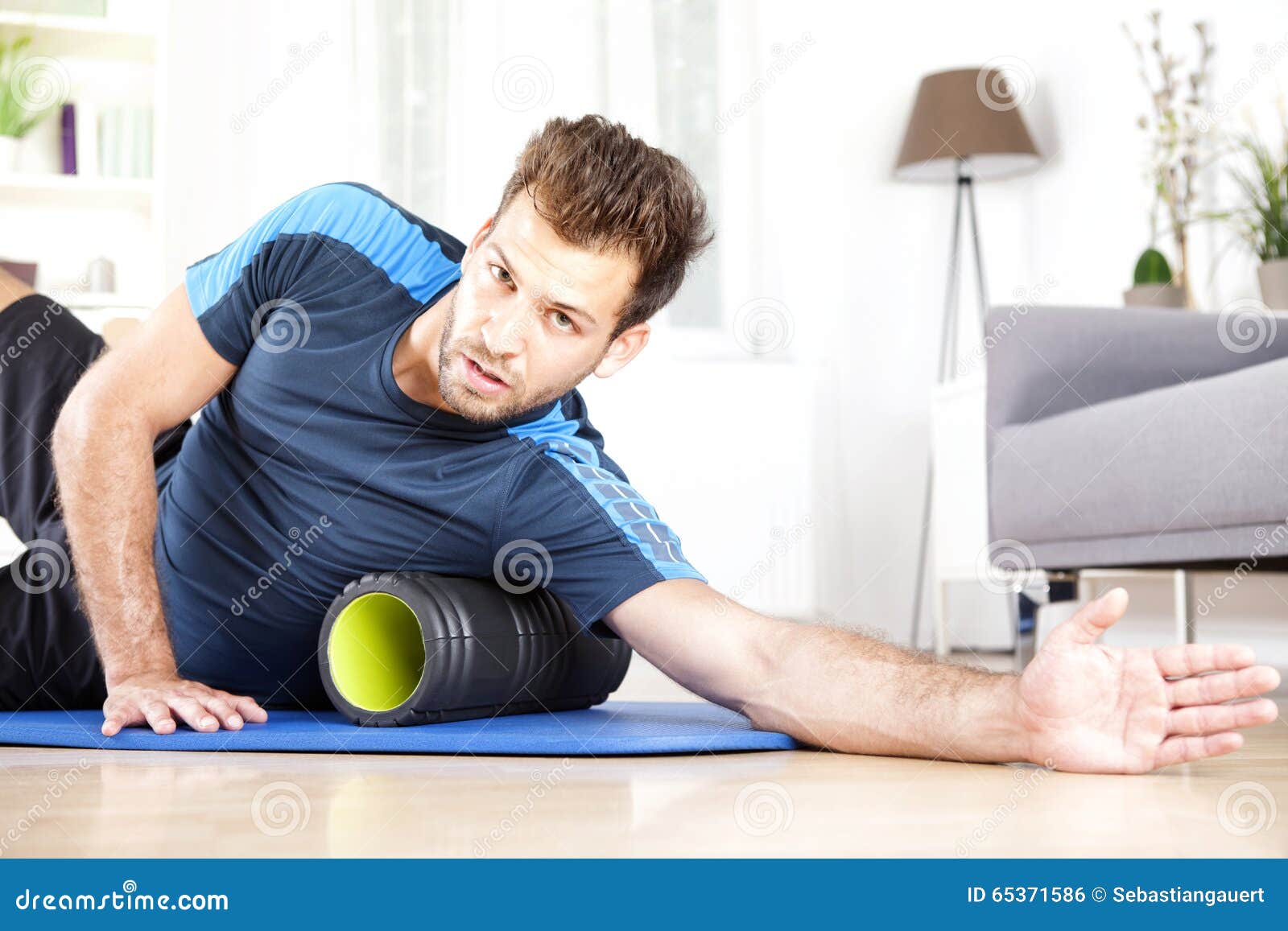 Handsome Guy Lying on Side with Foam Roller Stock Photo Image of roll
