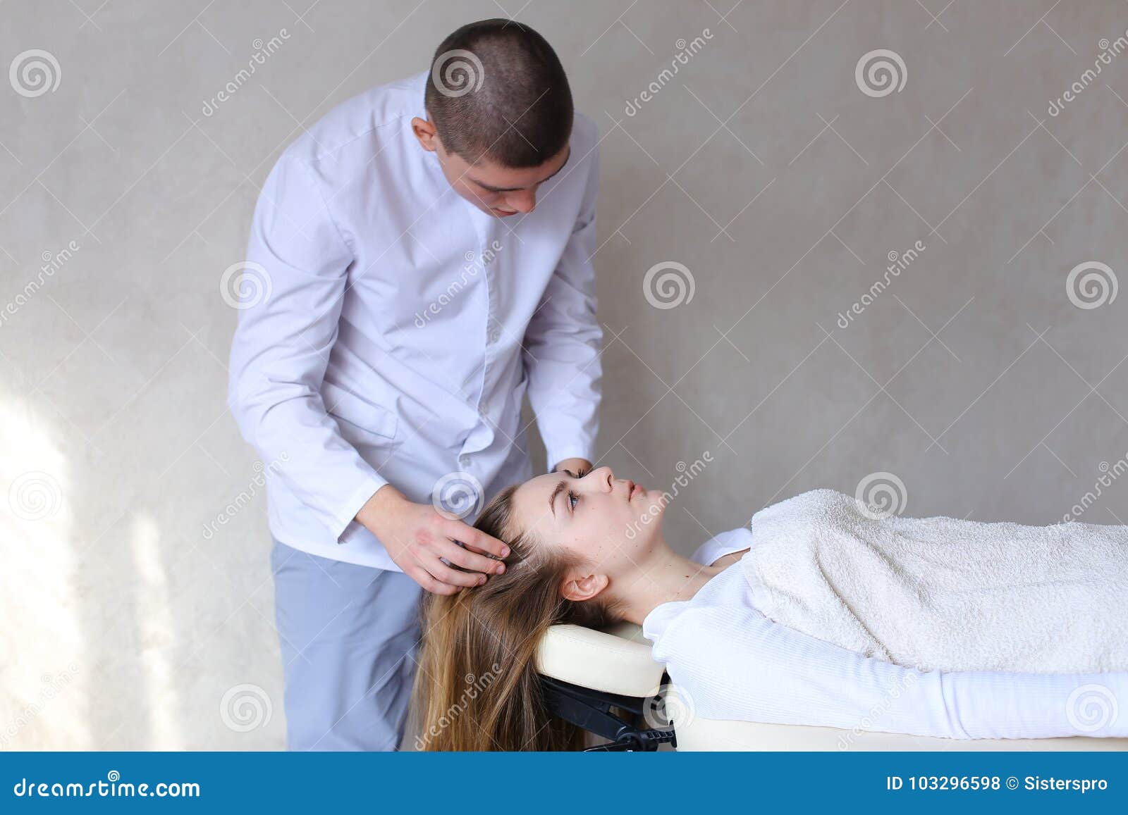 Handsome Guy Massage Therapist Doing Head Massage For Girl Clien Stock