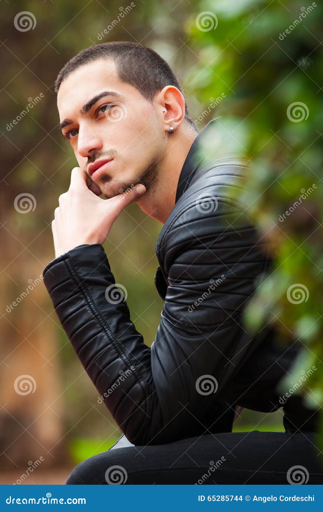 Portrait of a handsome serious man with a short hairstyle in a winter  stylish jacket in the street Stock Photo - Alamy