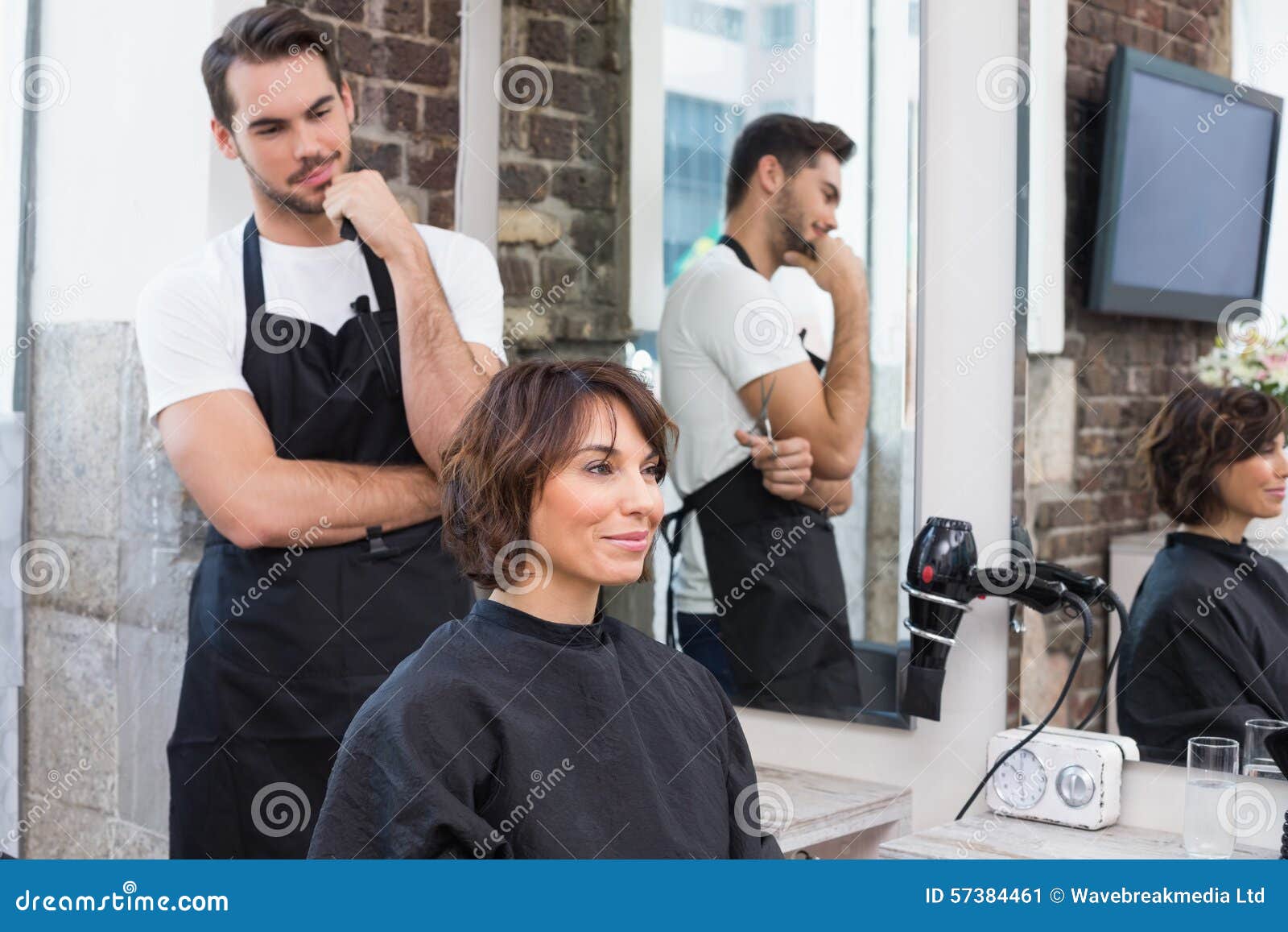 handsome hair stylist with client