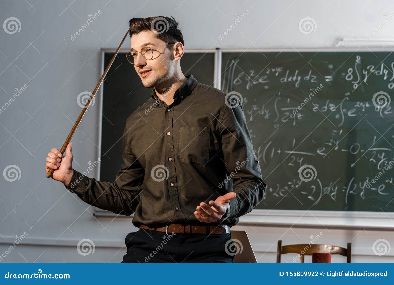 Handsome Male Teacher in Formal Wear Holding Wooden Pointer and