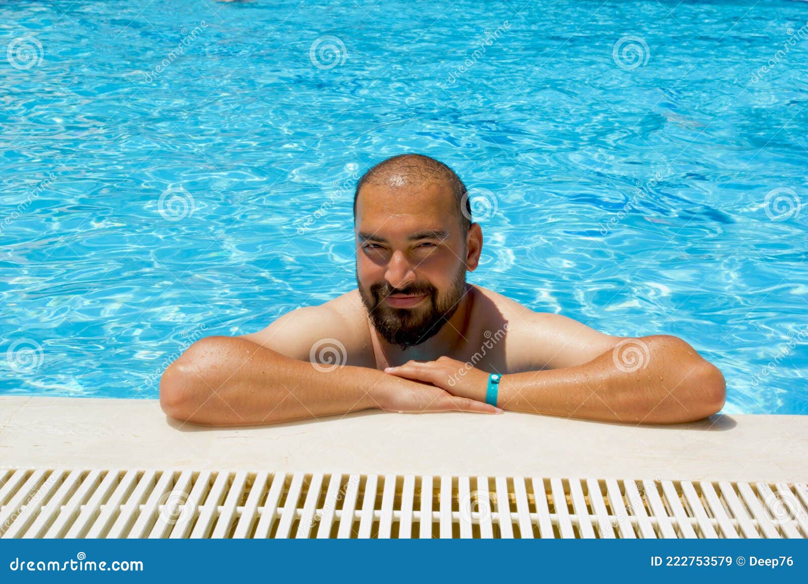 handsome man in the swimming pool in a resort