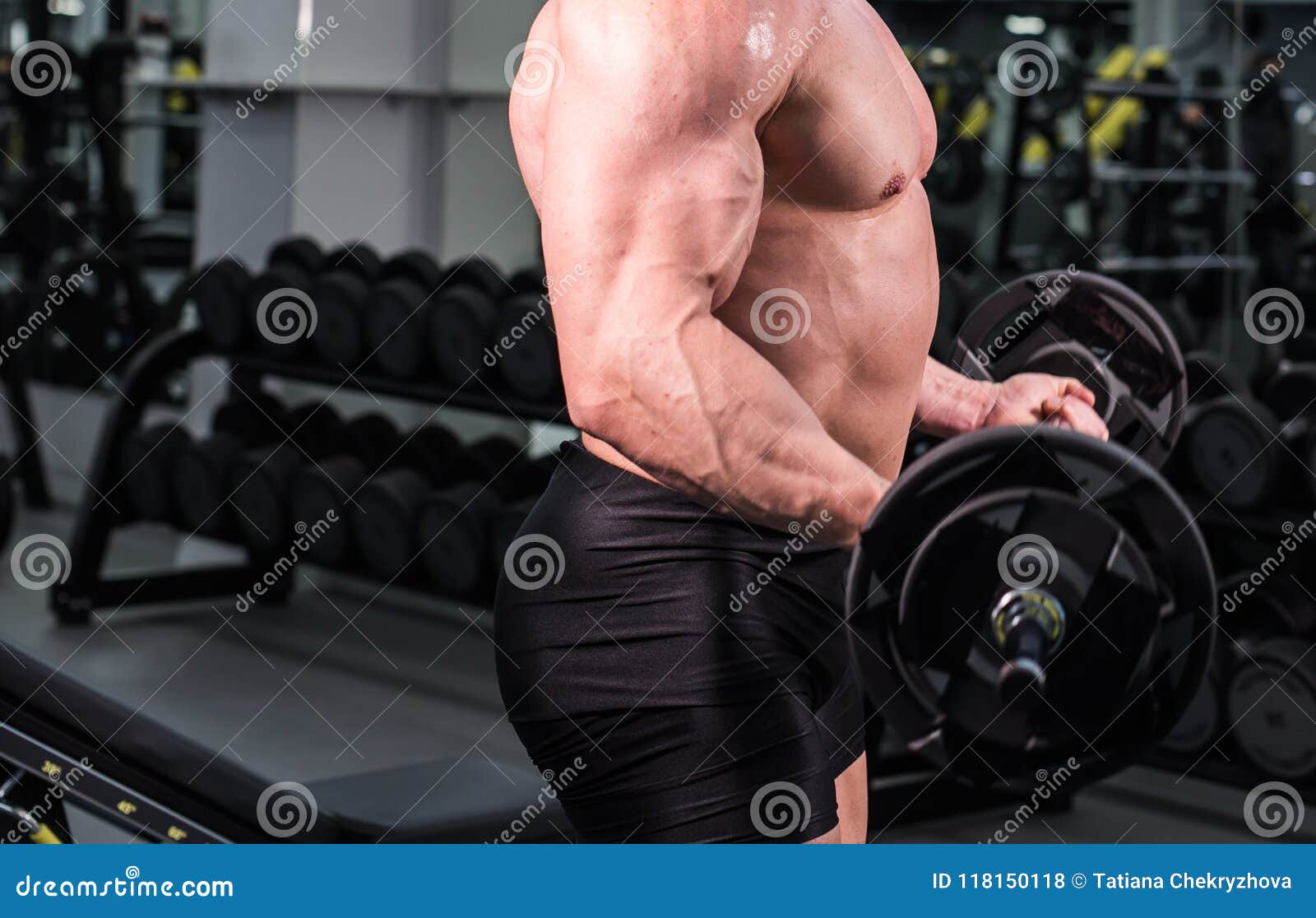 Close Up of Bodybuilder Man with Big Muscles in the Gym Stock Photo