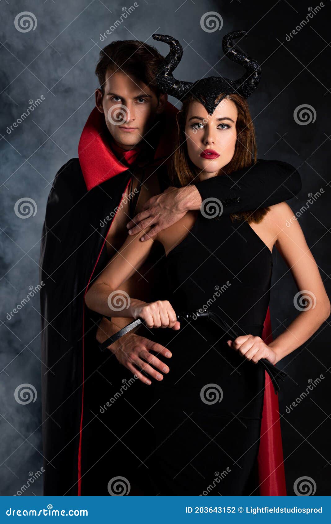 Shirtless Man Hugging Young Woman Standing in Lace Bra on Blue