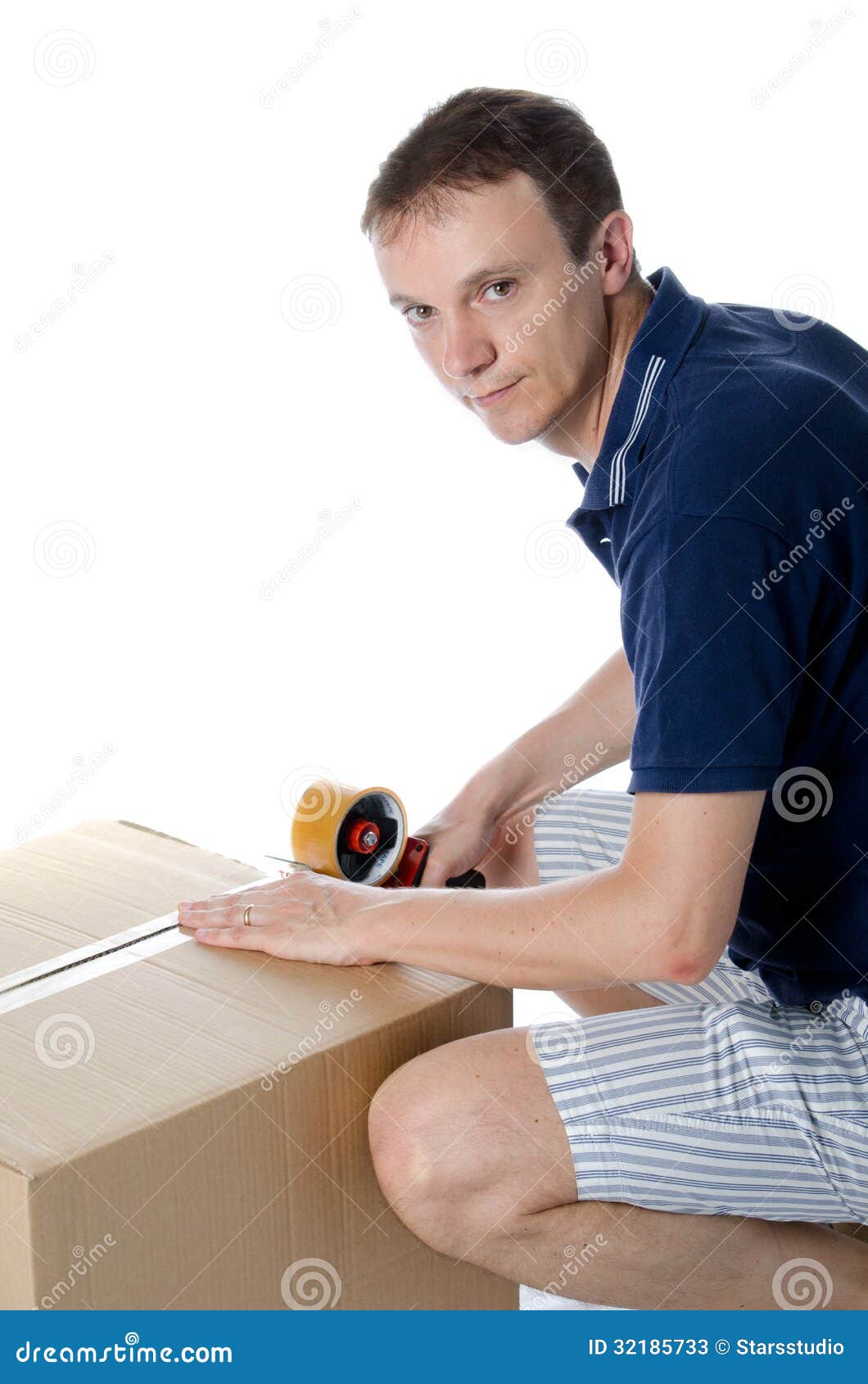 Handsome Man Closing Cardboard Box With Adhesive Tape Stock Image