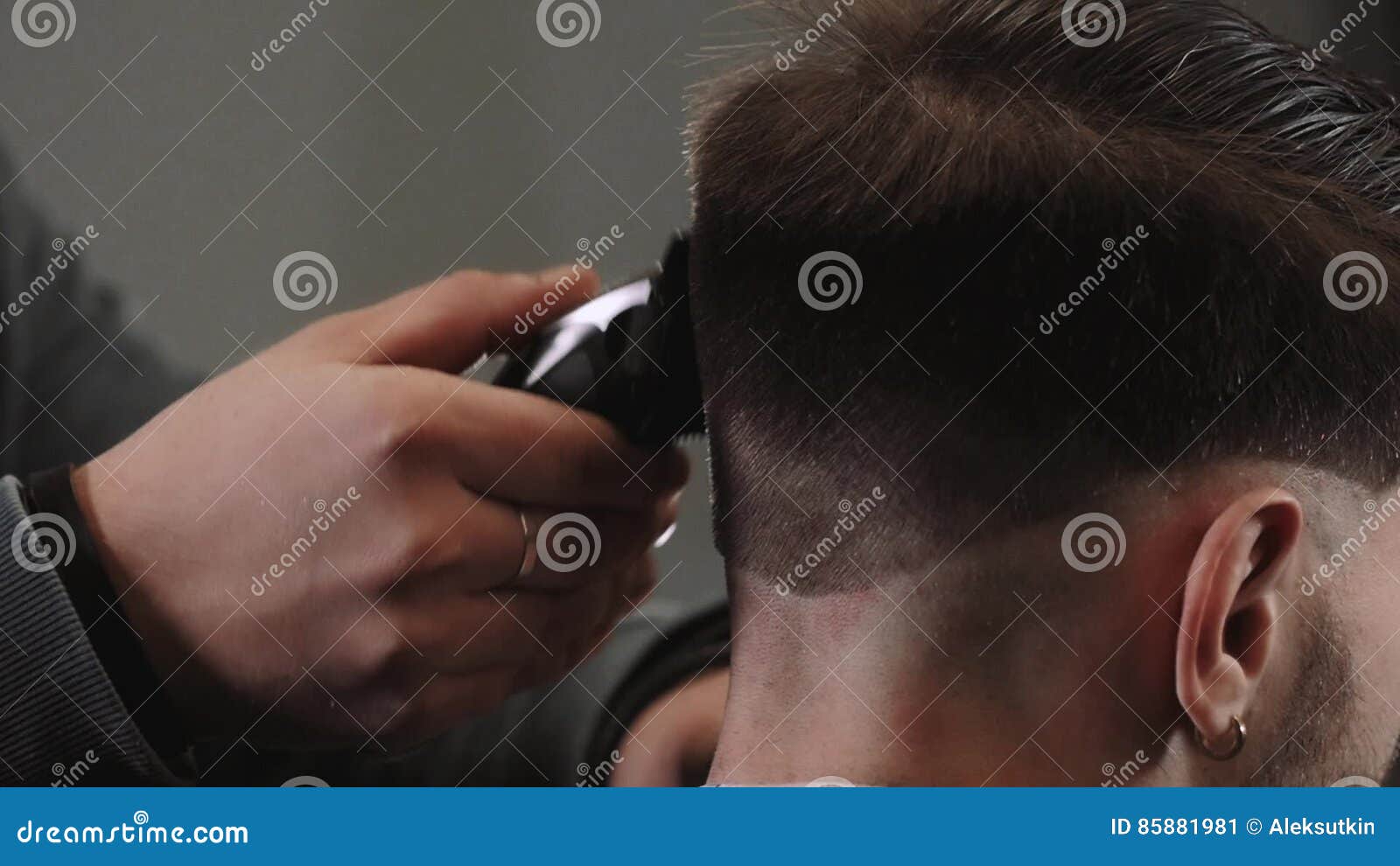 handsome man doing a close up haircut for man with black