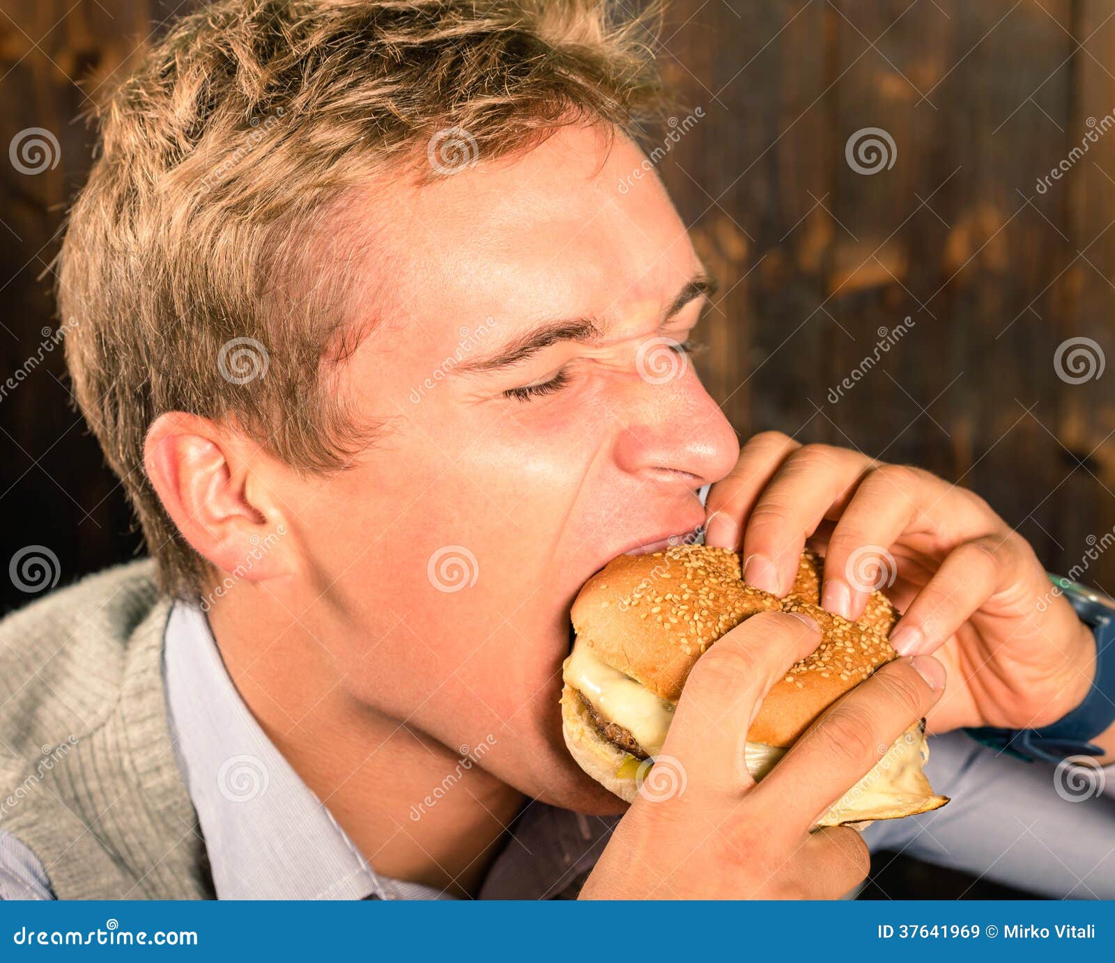 Handsome Man Eating Cheeseburger Stock Image Image of closed, huge
