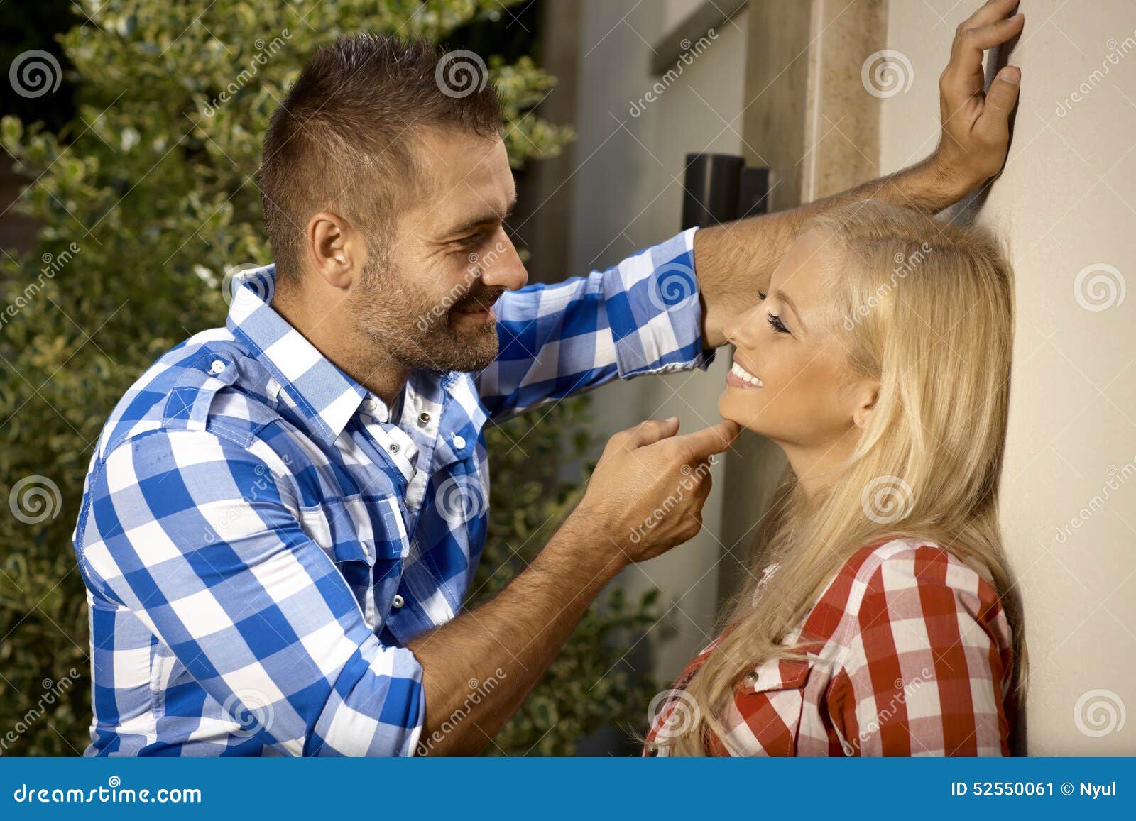 handsome man flirting with young woman outdoors