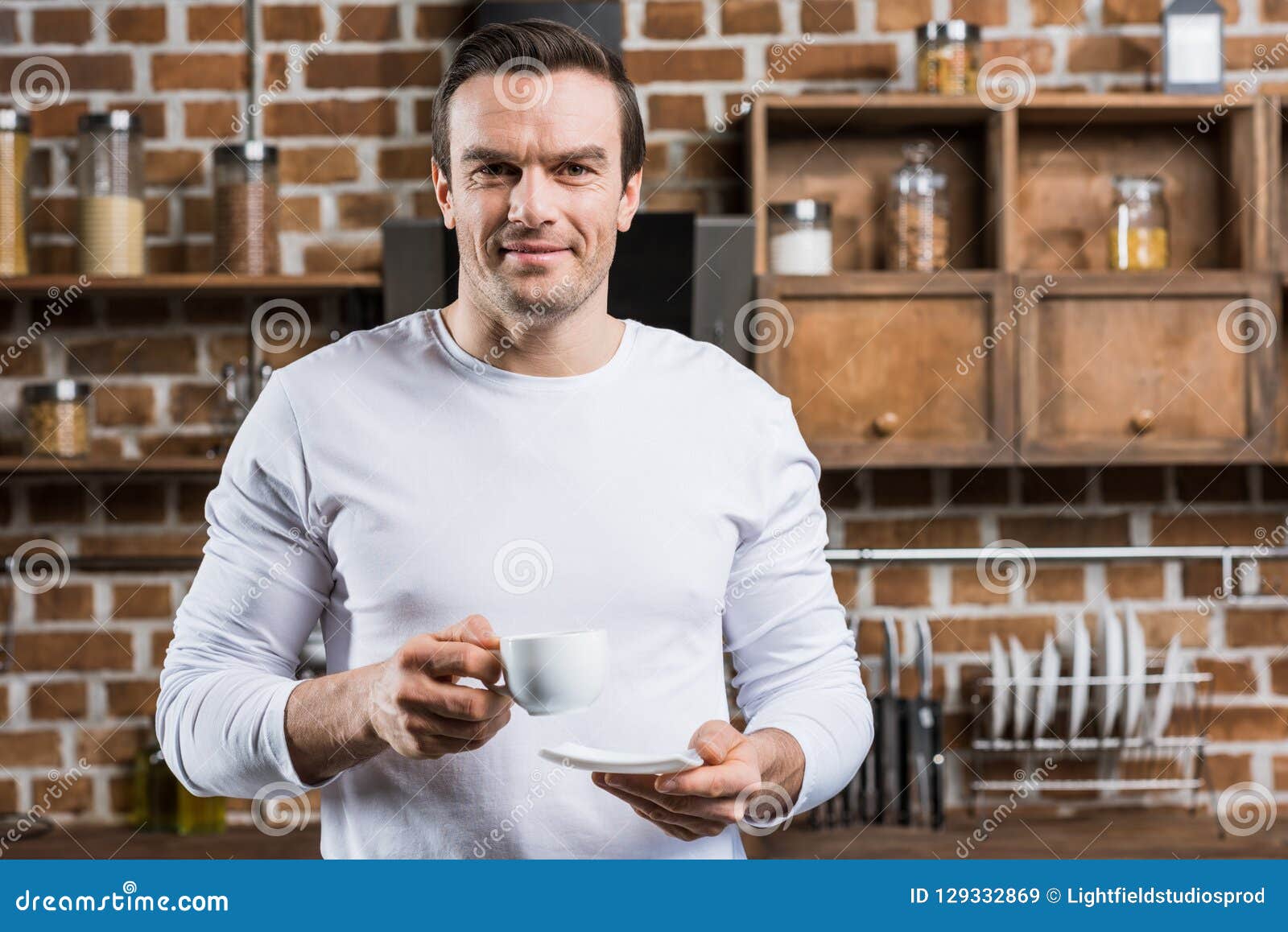 Handsome Man Holding Cup of Coffee and Smiling at Camera Stock Image ...