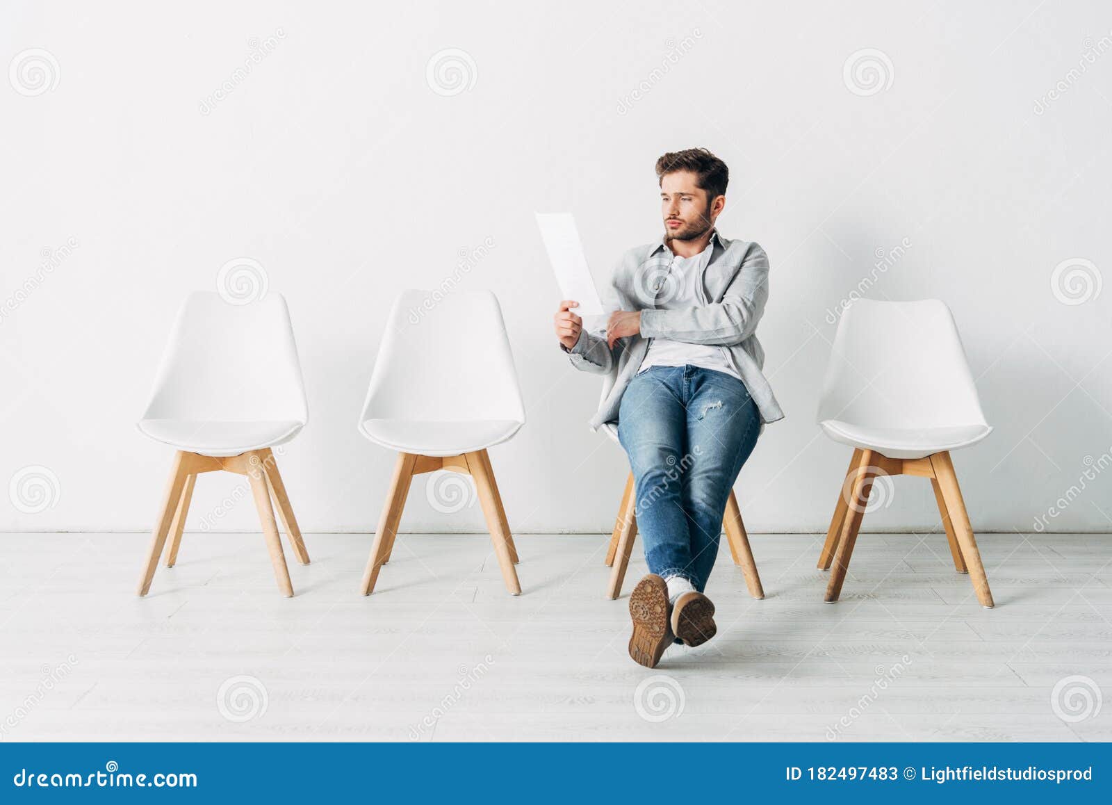 Handsome Man Looking at Resume while Sitting on Chair Stock Image ...