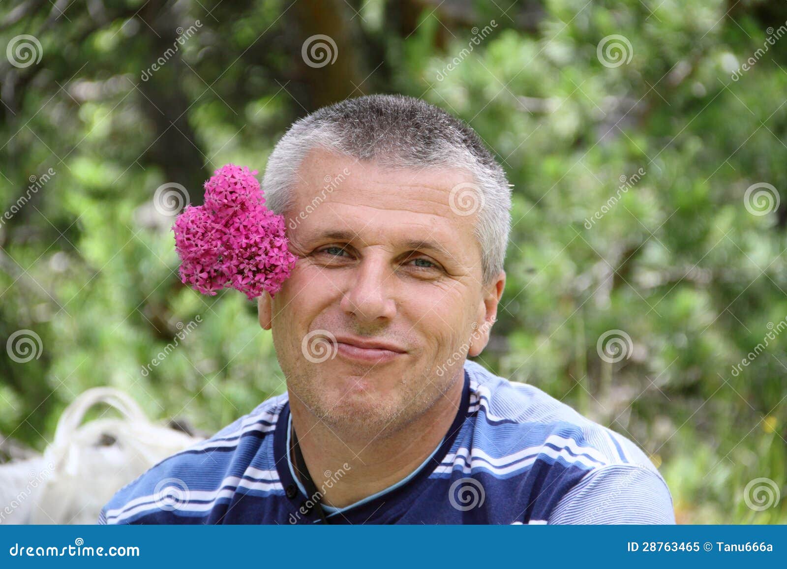 handsome-man-pink-flower-behind-28763465