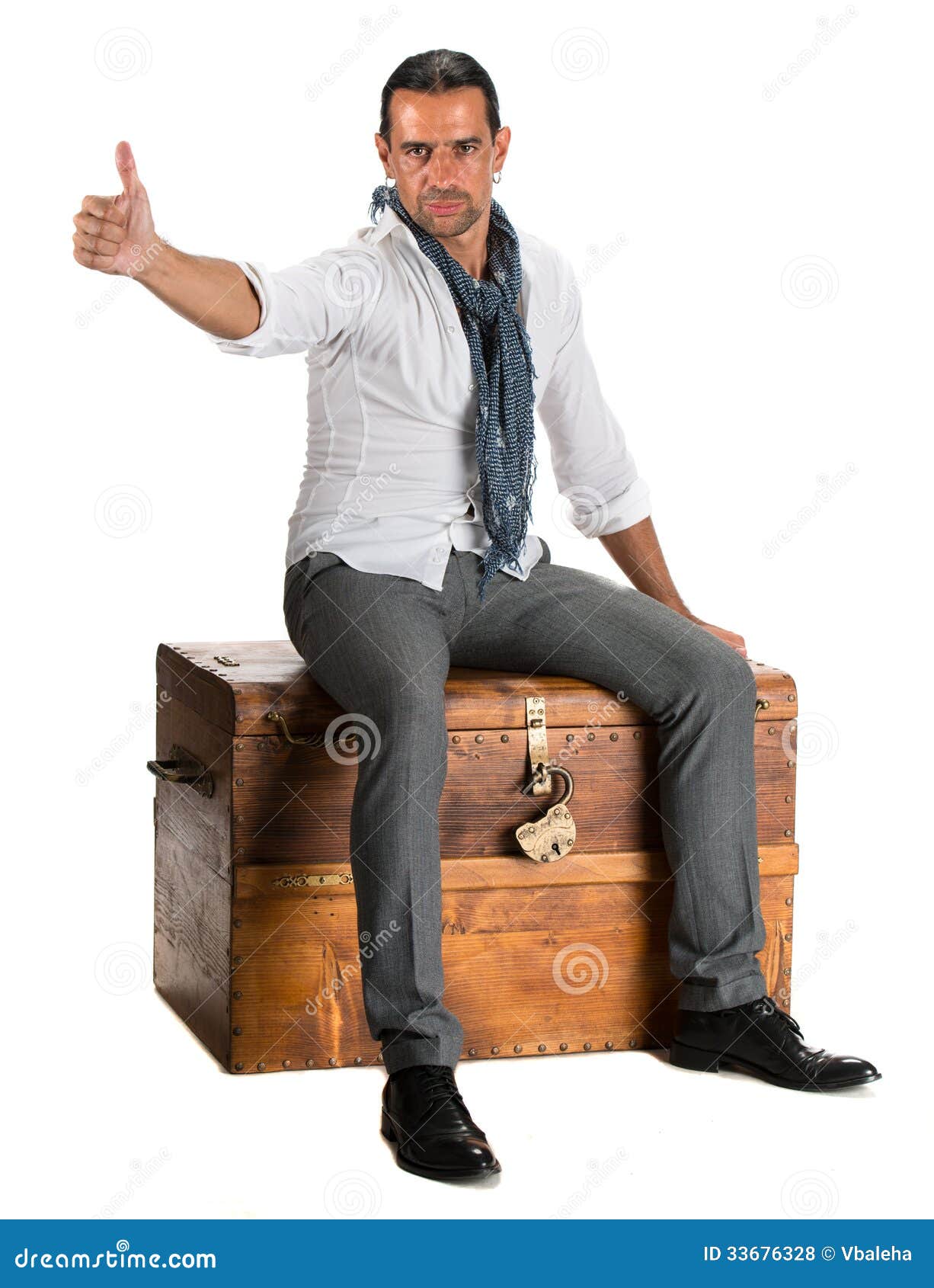 Handsome Man Sitting On A Wooden Chest And Showing Ok Sign ...