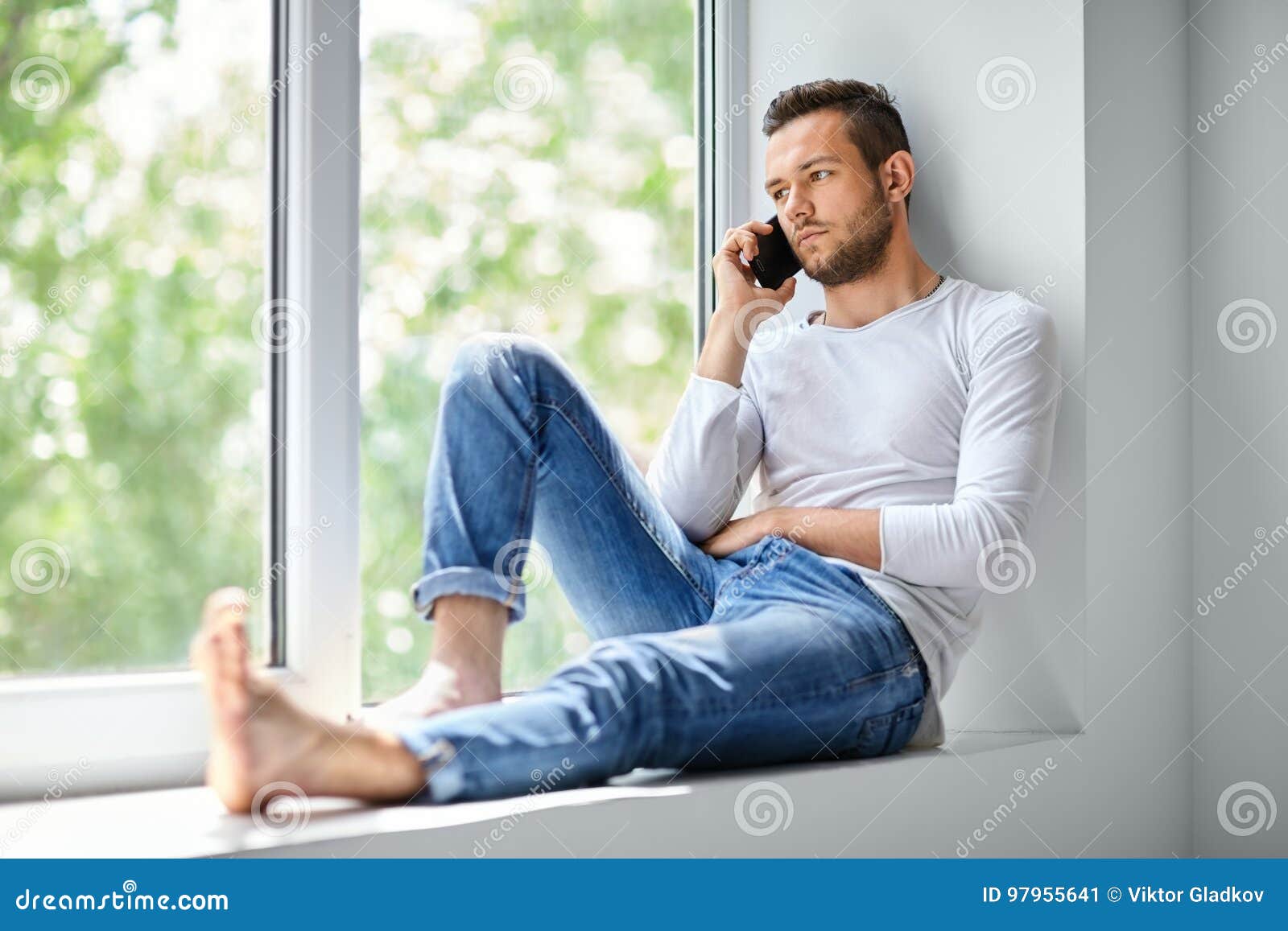 Free Stock Photo of Young Man sitting near window