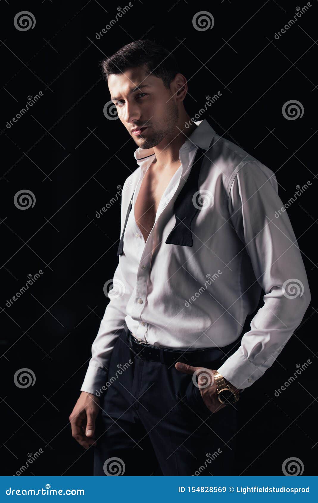 Handsome Man in White Shirt and Hand in Pocket Looking at Camera while ...