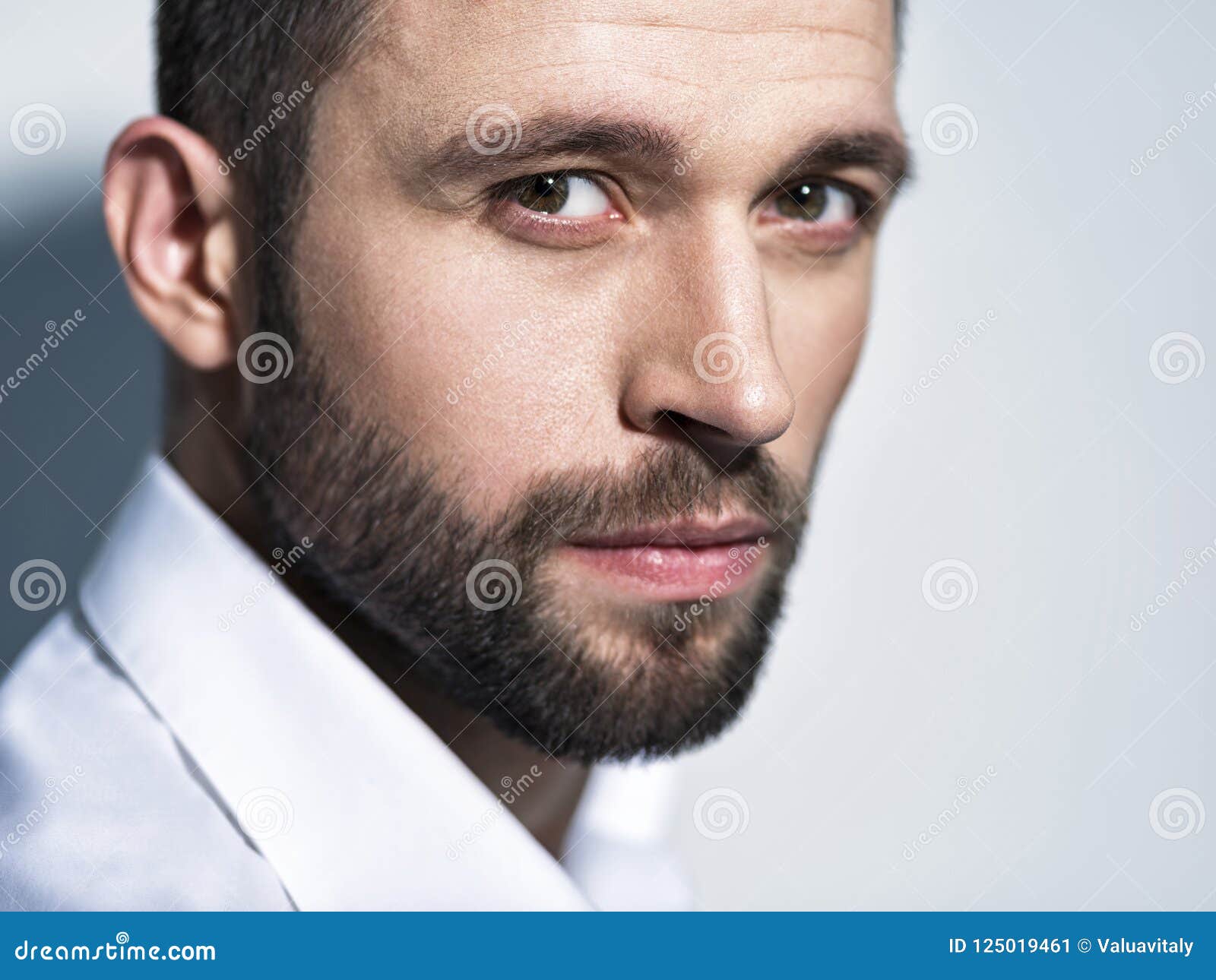 Handsome caucasian white male with black short hair and stubble with light  blue t shirt, considering thinking Stock Photo | Adobe Stock