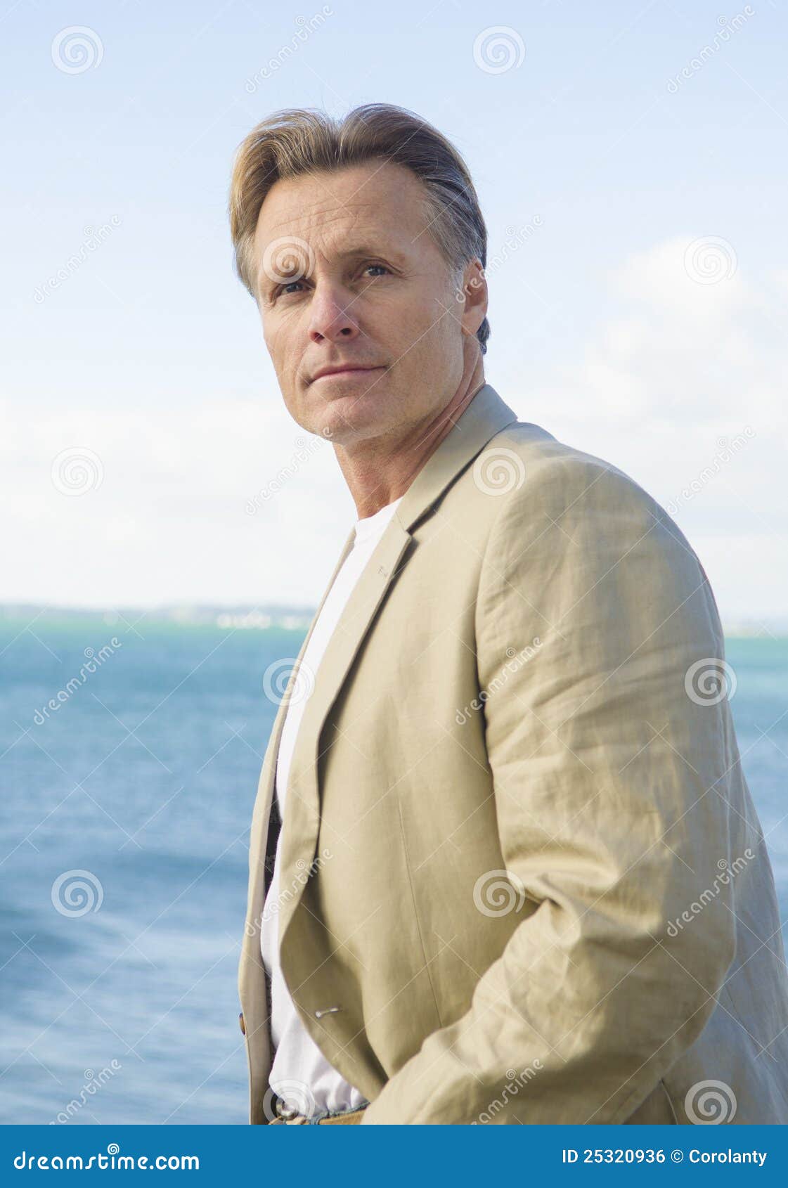 handsome mature man in beige blazer