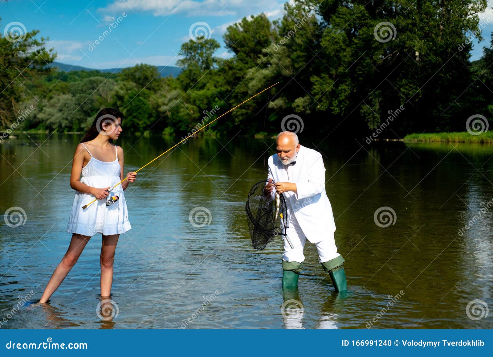 Handsome Mature Man Fishing with Young Woman in White Dress. Man