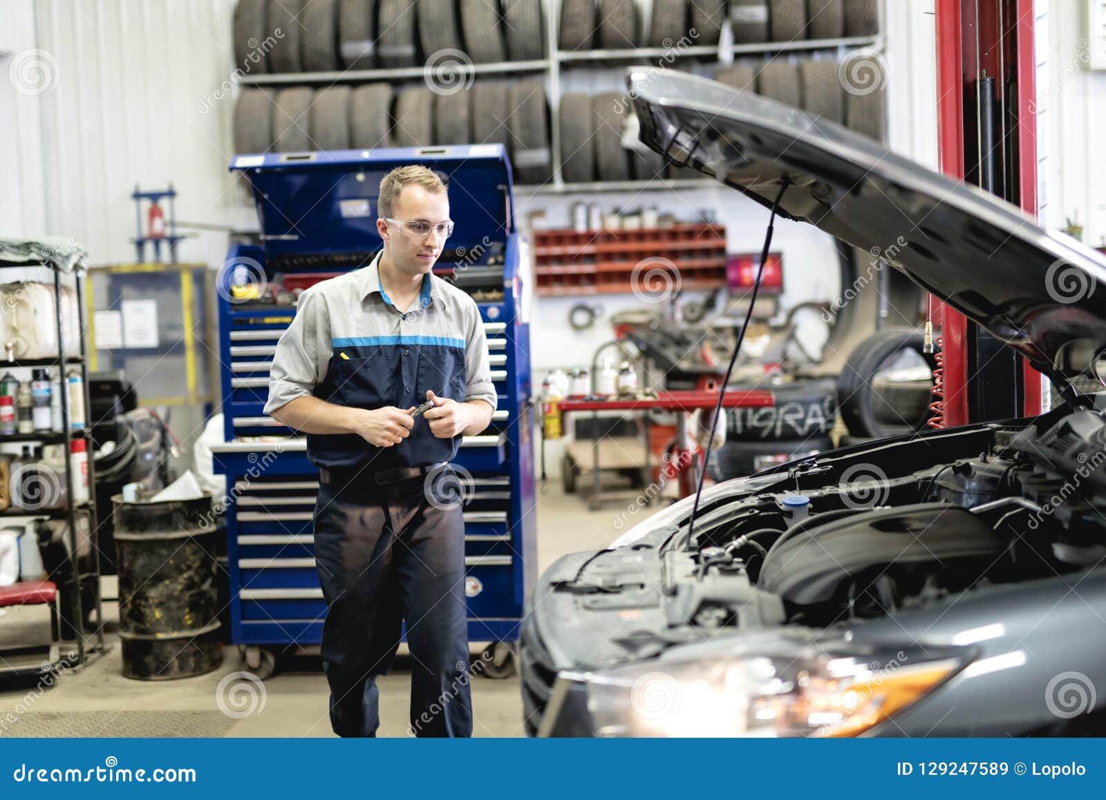 Handsome Mechanic Job in Uniform Working on Car Stock Image Image of