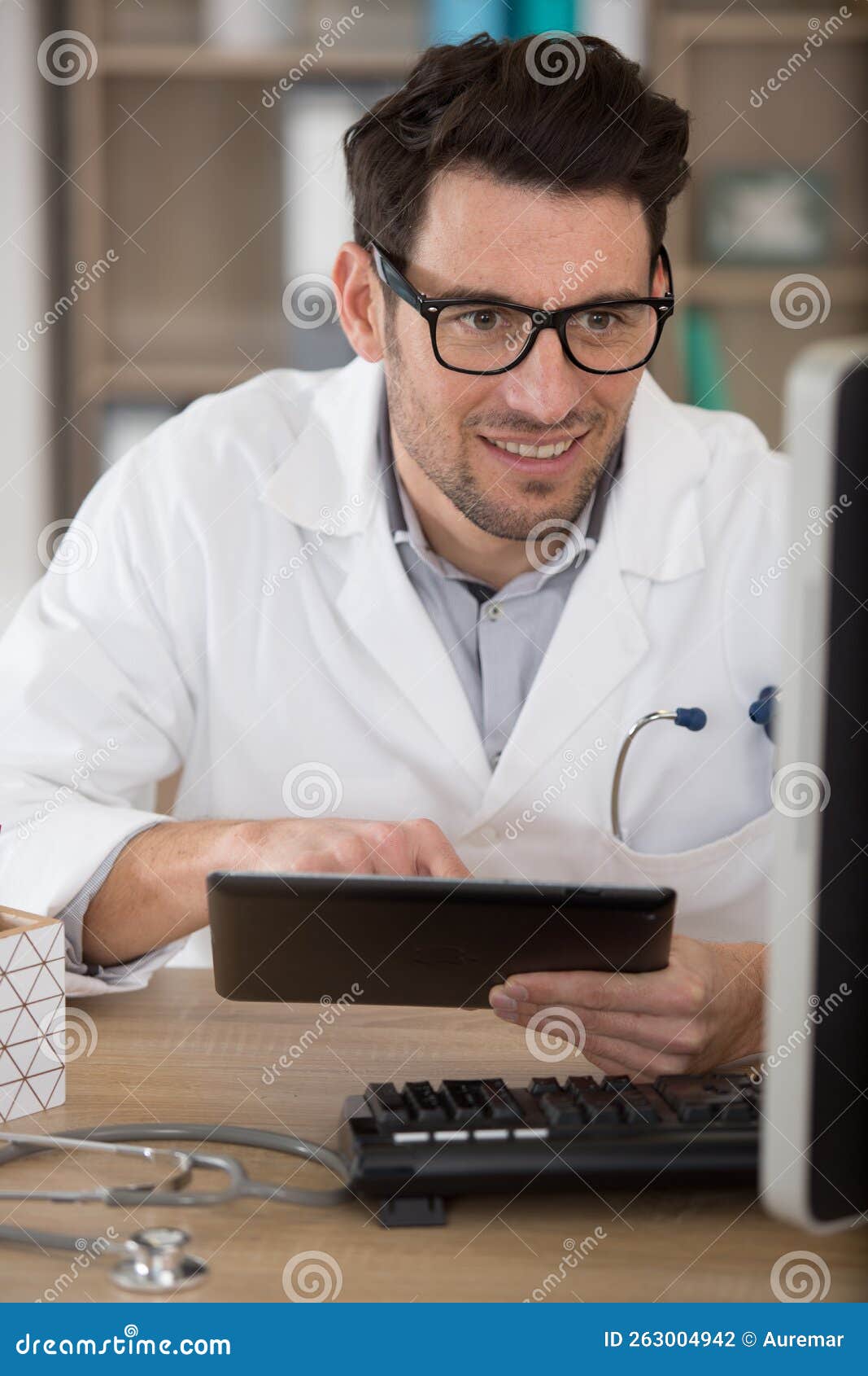 Handsome Medical Doctor in Office Using Digital Tablet Stock Photo