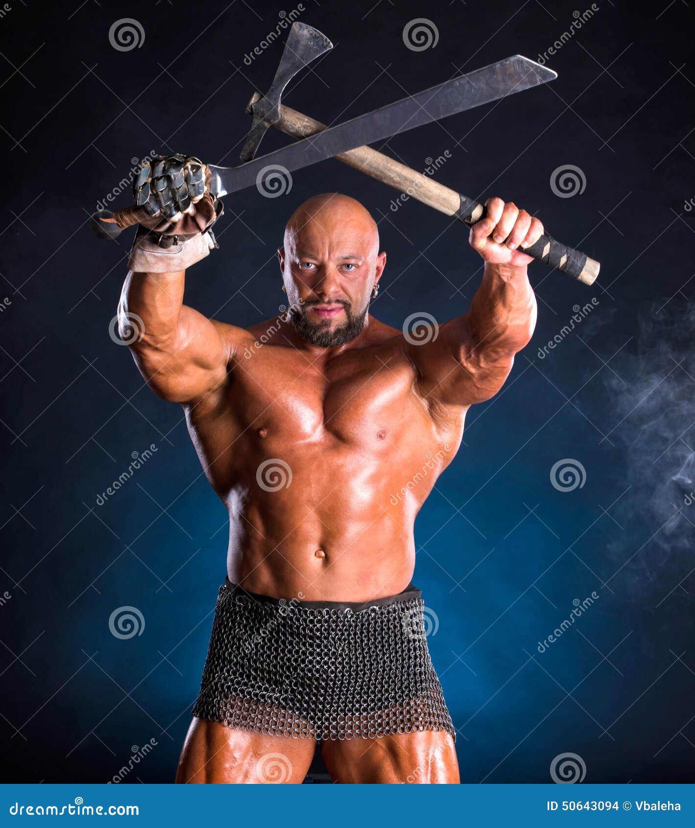 Handsome Muscular Ancient Warrior With Axe And Sword Stock Photo