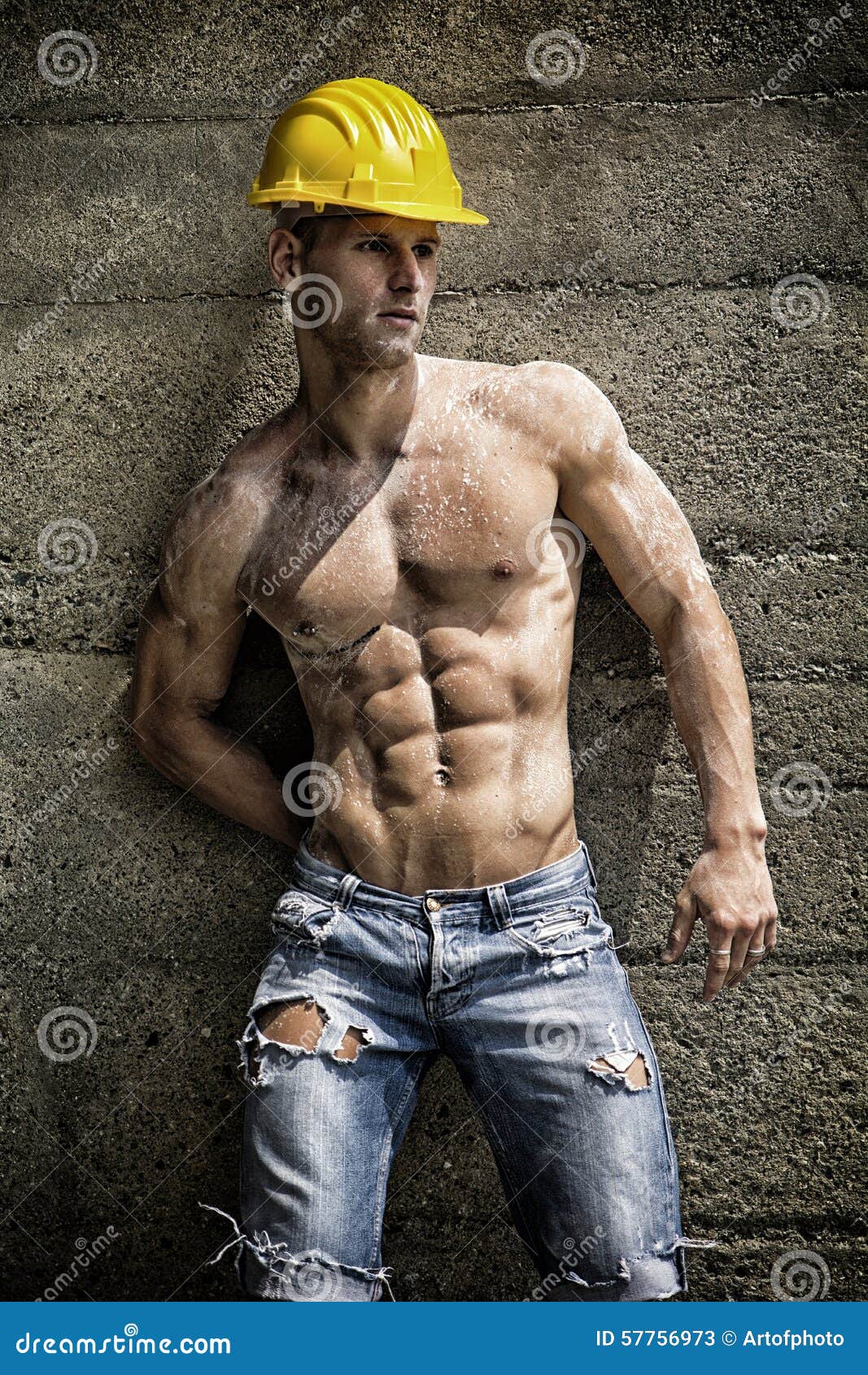 Muscular construction worker shirtless in building site 