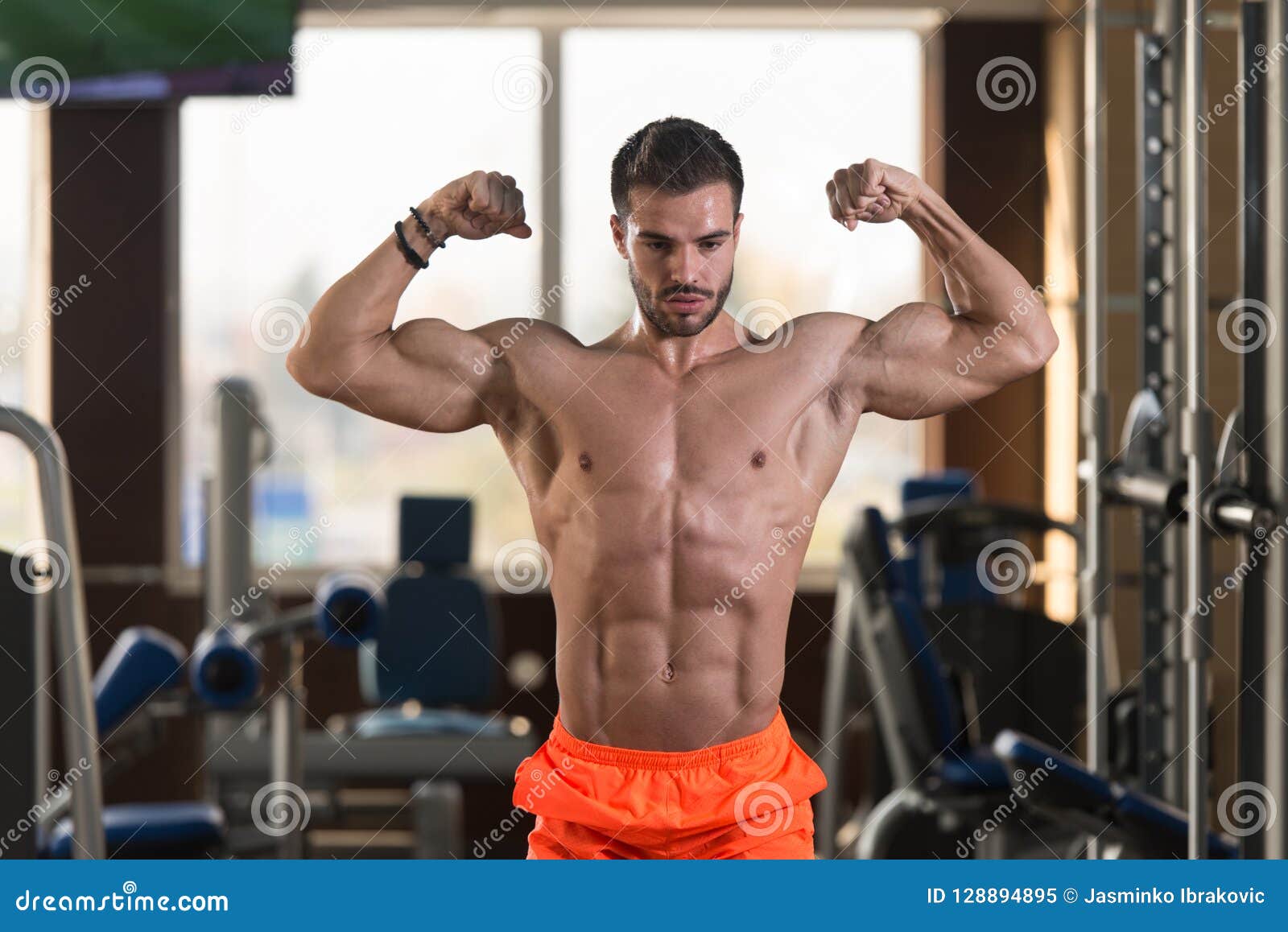 Muscular Man Flexing Muscles In Gym Stock Photo - Image of 