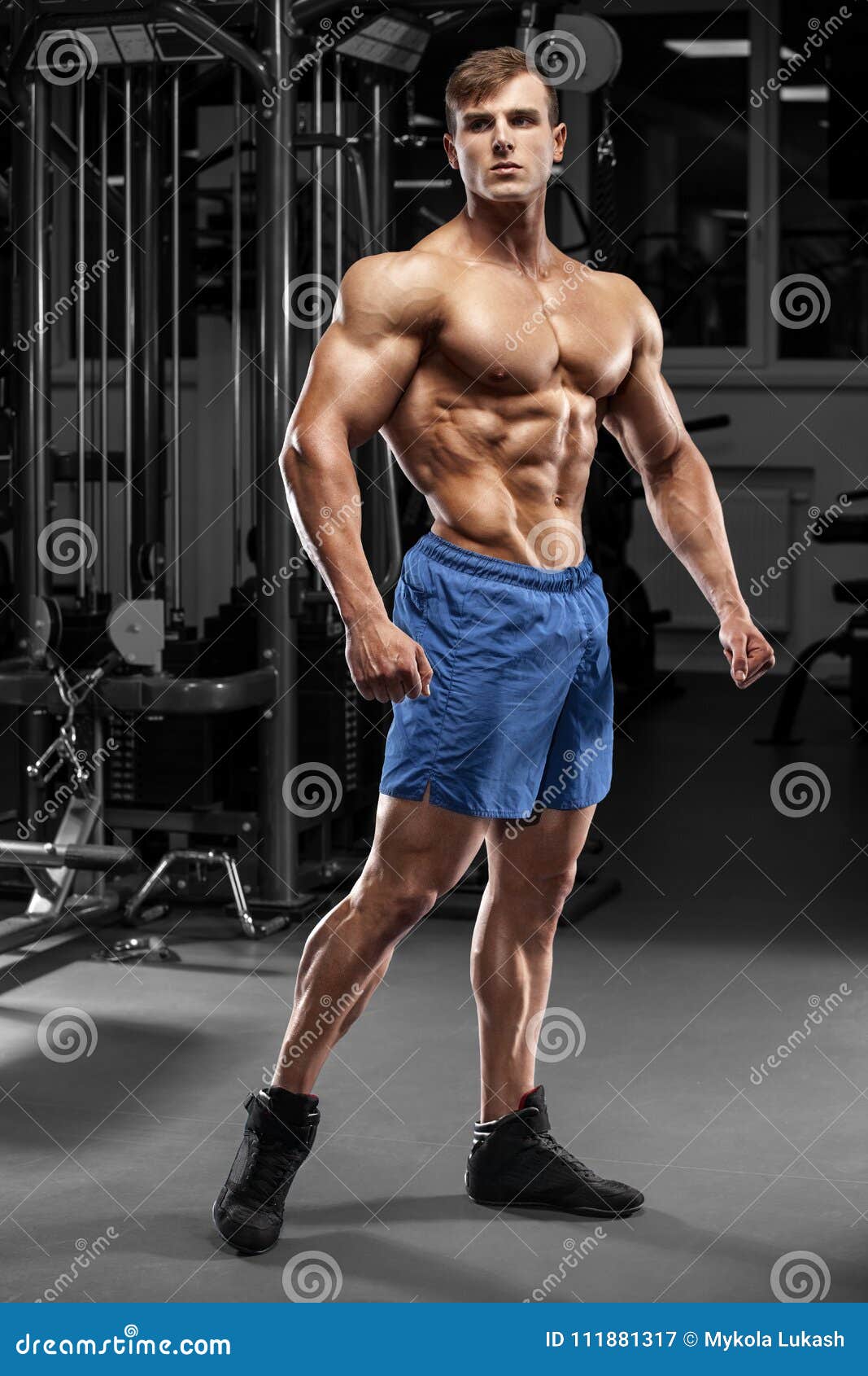 Handsome muscular man in gym, strong male naked torso abs 