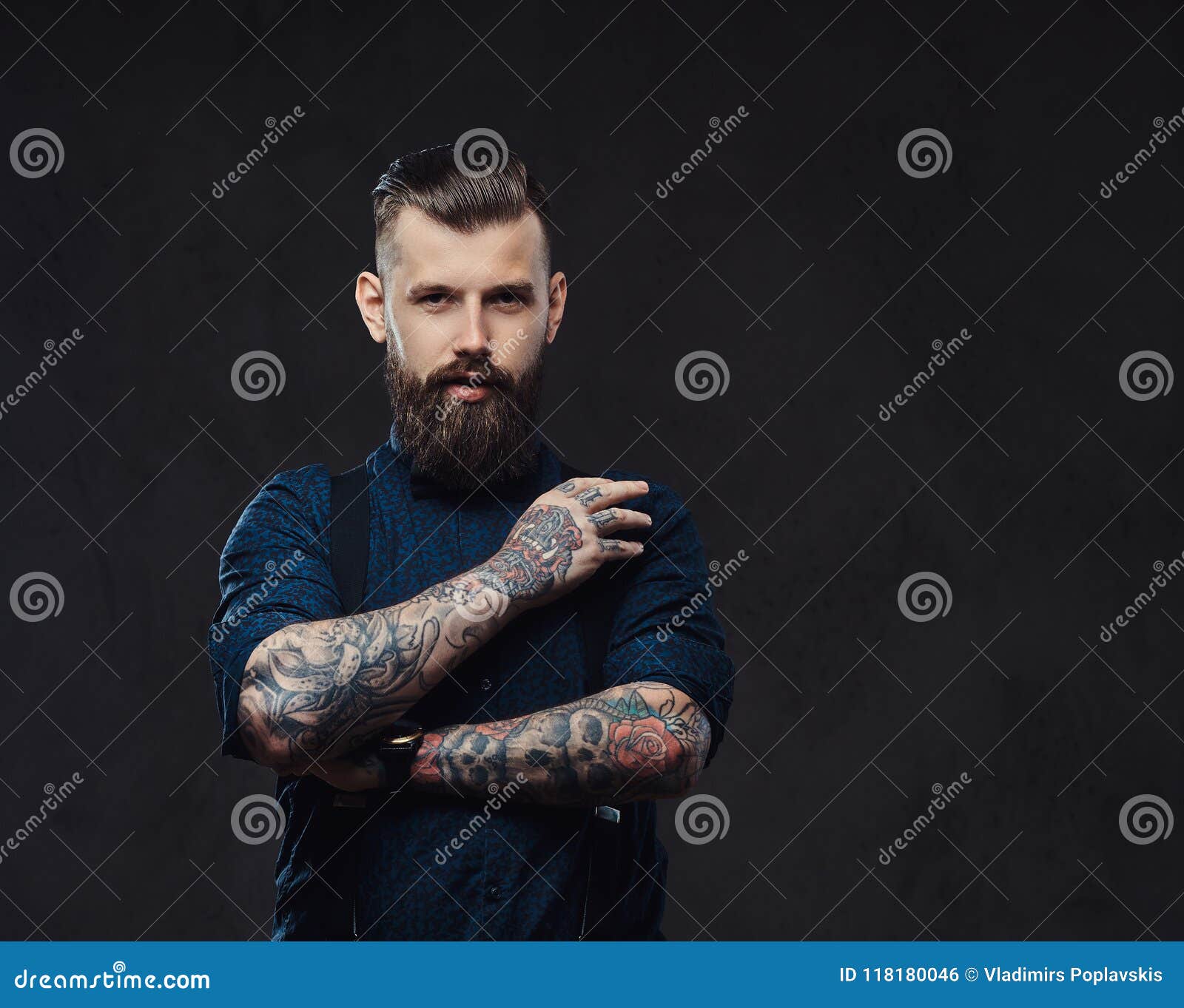 Handsome Old-fashioned Hipster in a Blue Shirt and Suspenders, Standing ...